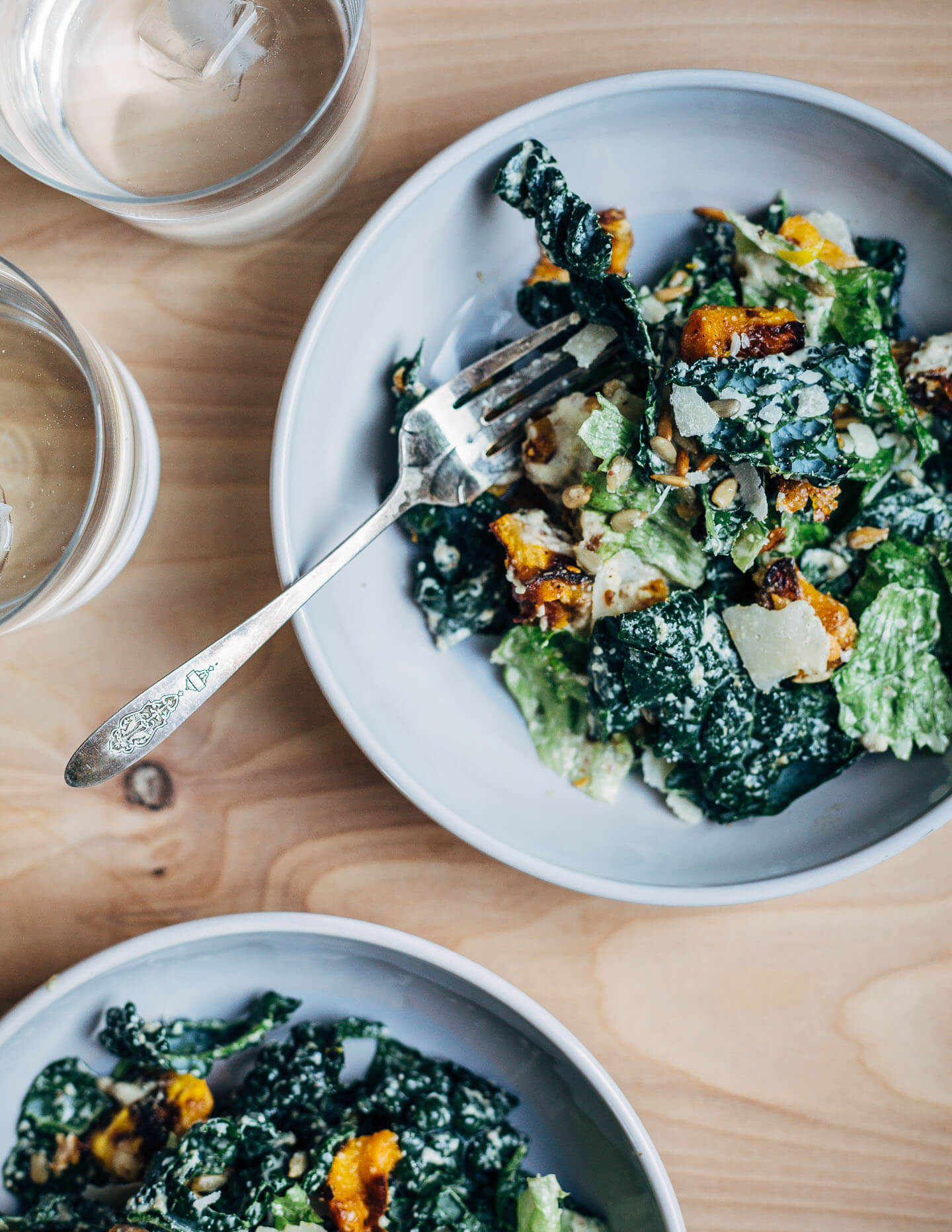 Complex, layered, and rich, this romaine and kale Caesar salad with Parmesan-crusted butternut squash "croutons" and garlicky sunflower seed Caesar dressing embraces all the best things about the transition to fall cooking.