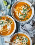 This vegan coconut curry winter squash soup is richly flavored with alliums, ginger, and Thai chilies, along with Thai curry paste, fresh herbs, and toasted winter squash seeds. It's simple too – it cooks up in one pot and comes together in about 30 minutes!