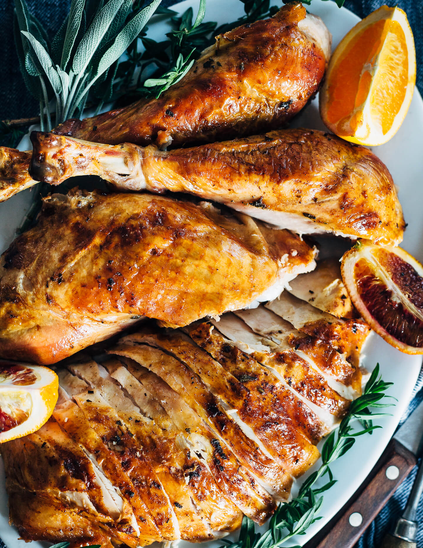 Citrus and herb roasted turkey, carved and ready to serve. 