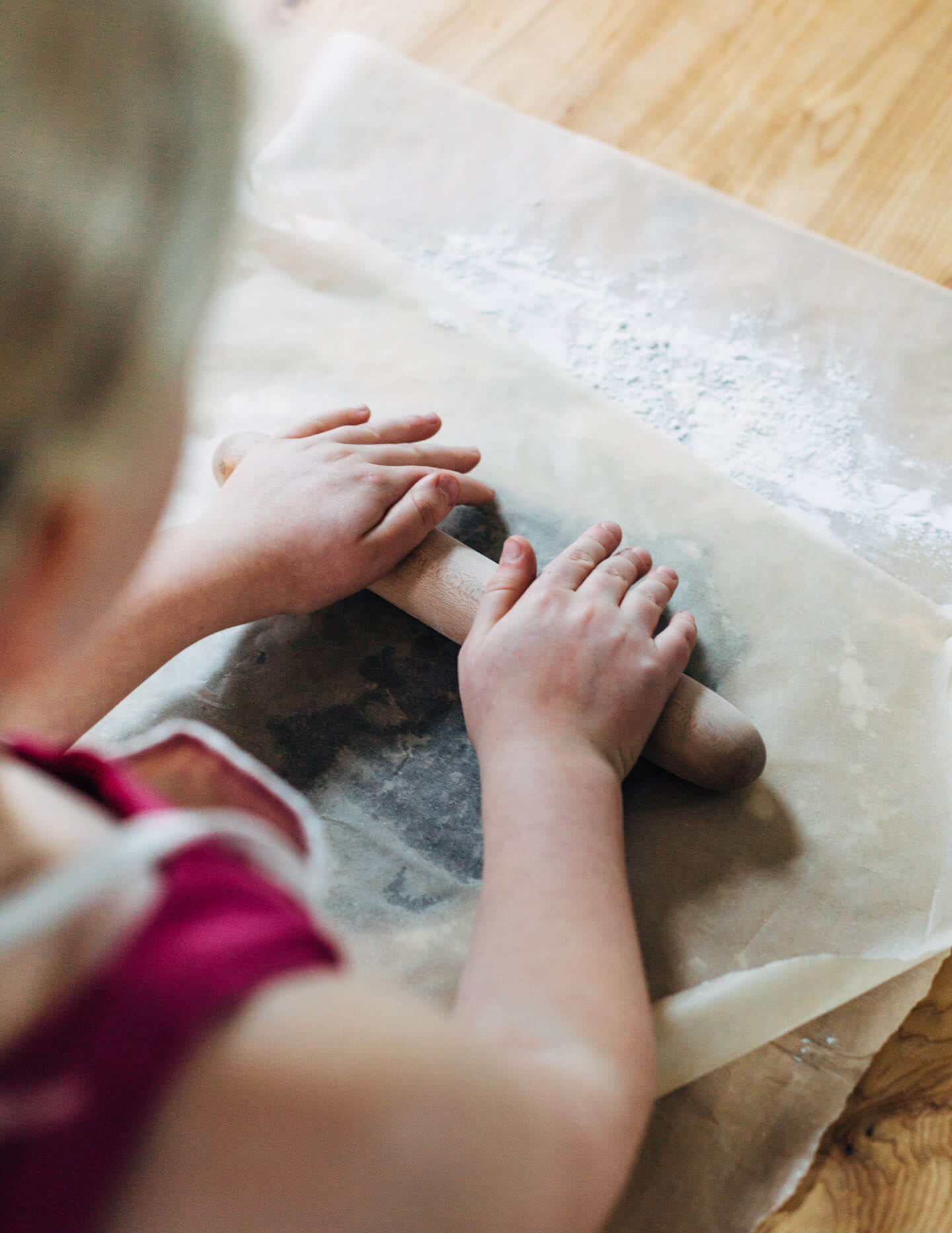 Rolling out gingerbread cookie dough with kids. 