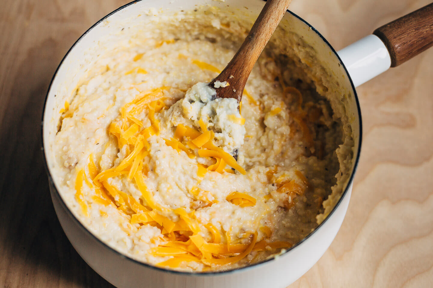 Swirling cheddar into creamy stone ground grits. 
