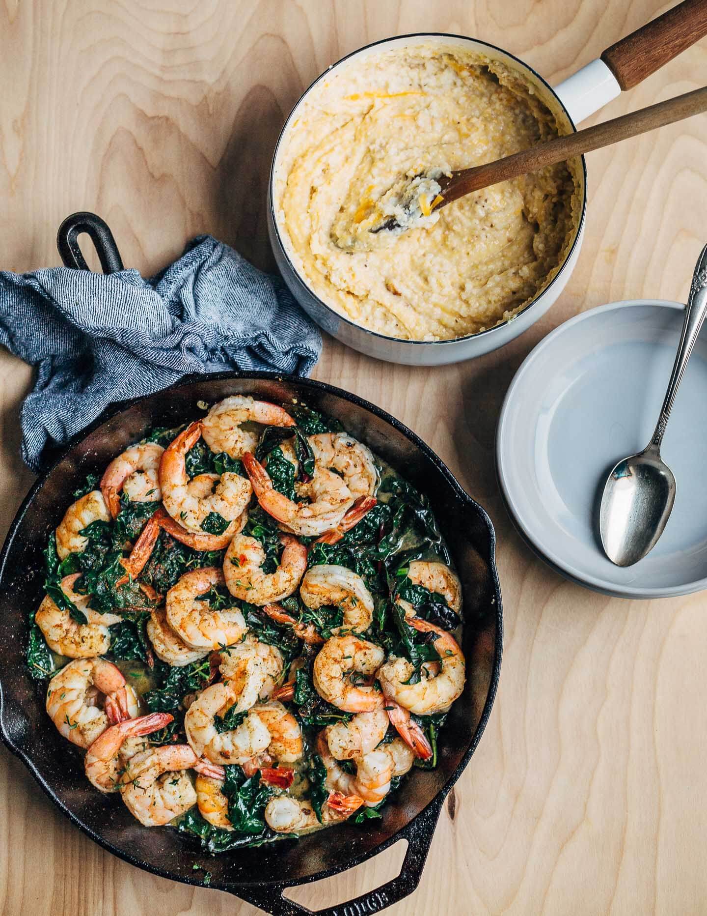 Bringing the shrimp and grits and greens together, just before serving. 
