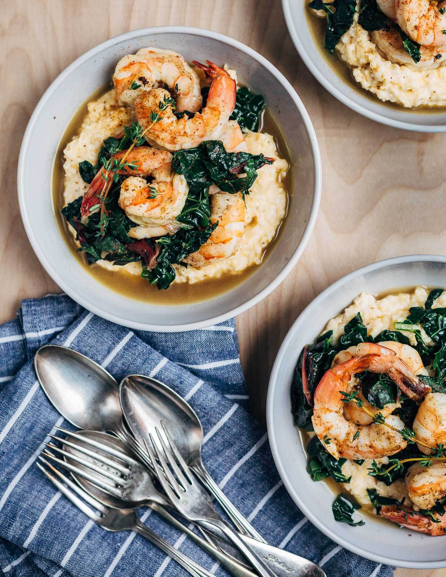 Add some leafy greens to your shrimp and grits! This recipe for shrimp and grits and greens features delicate shrimp with lots of depth, toothsome, buttery stone ground grits, and dark leafy greens cooked until tender in a lightly sweet, wonderfully garlicky shrimp broth.