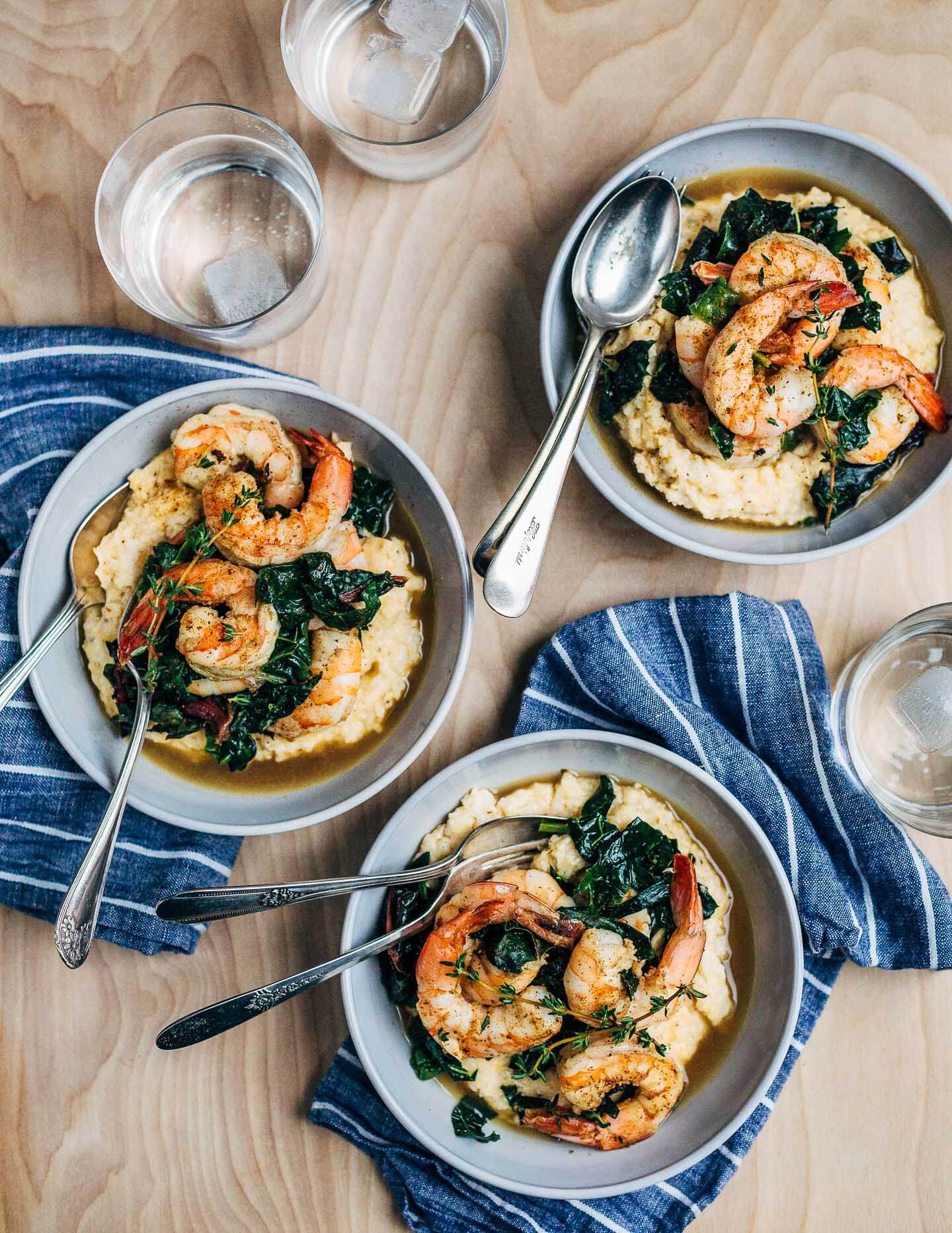 Add some leafy greens to your shrimp and grits! This recipe for shrimp and grits and greens features delicate shrimp, toothsome stone ground grits, and tender leafy greens.