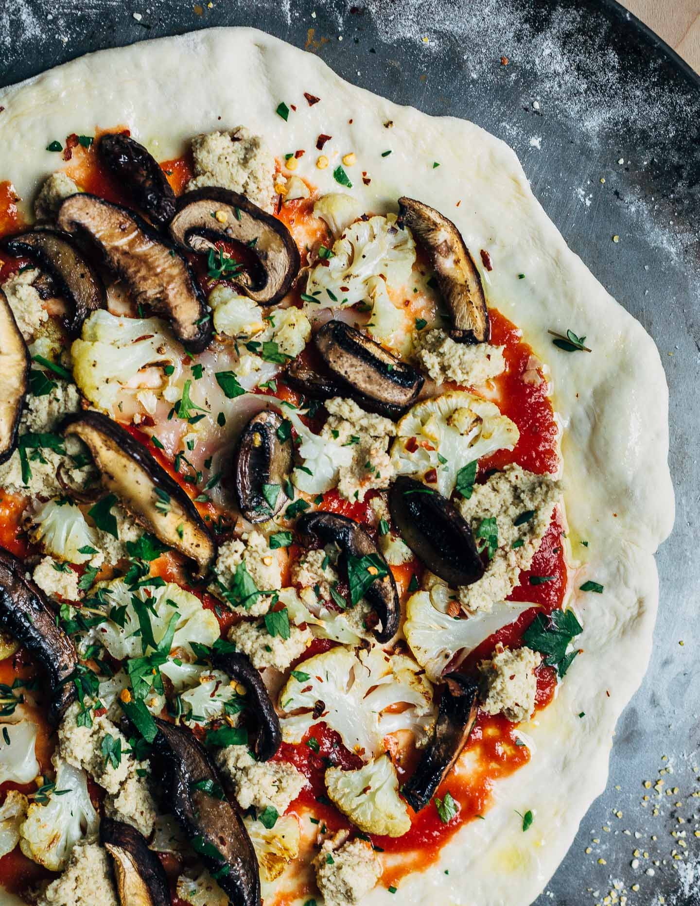 Roasted cauliflower and mushrooms vegan pizza, ready for the oven.