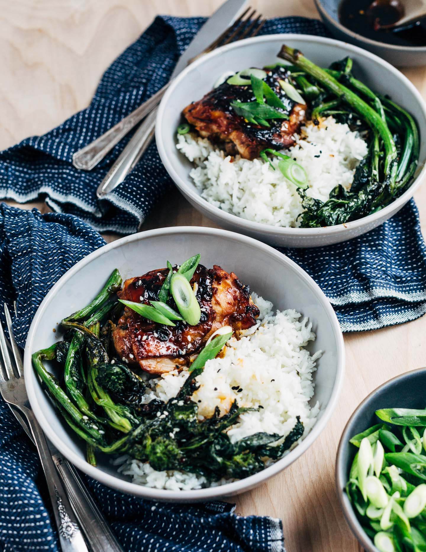 Honey-soy skillet chicken served in low bowls with rice and extra honey-soy sauce. 