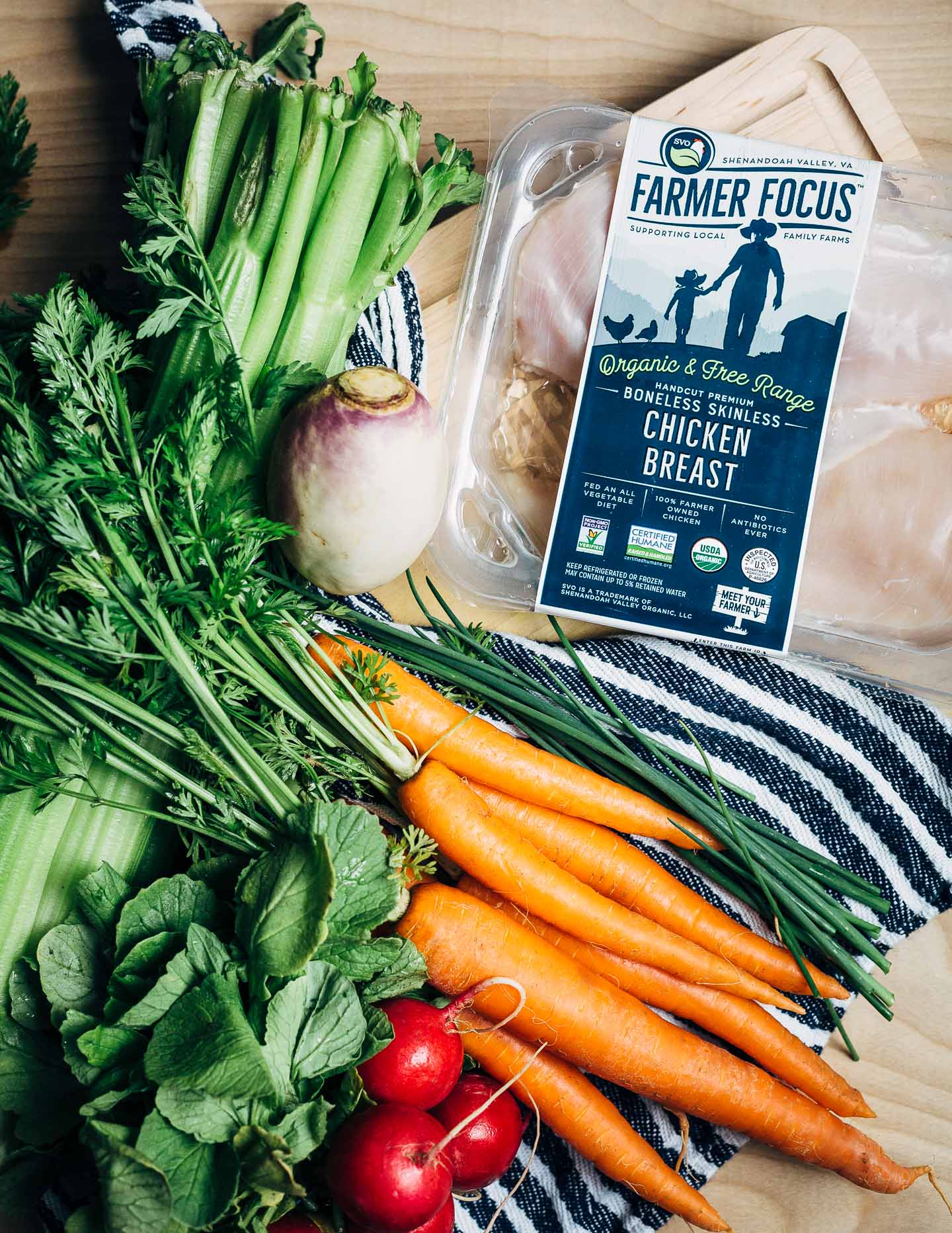 Chicken and dumpling soup ingredients, including Farmer Focus chicken, carrots, celery, and radishes. 