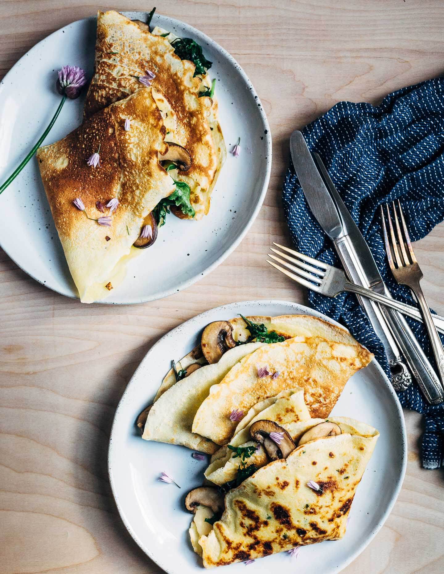 Vegetarian savory crepes with mushrooms, garden greens, and garlic. 