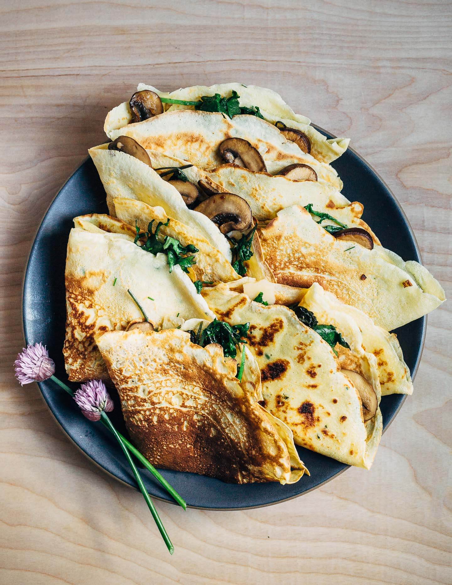Savory crepes with mushrooms, leafy greens, and garlic make for a lovely spring-inspired vegetarian meal. Made with all-purpose flour, these savory crepes are surprisingly easy to make and cook up quickly. The options for filling your savory crepes are nearly endless.