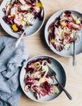 A punchy shaved radish and Parmesan salad featuring shaved radishes, fennel, and Parmesan tossed with radicchio, lemon zest, spicy olive oil, and nutty fried garlic.