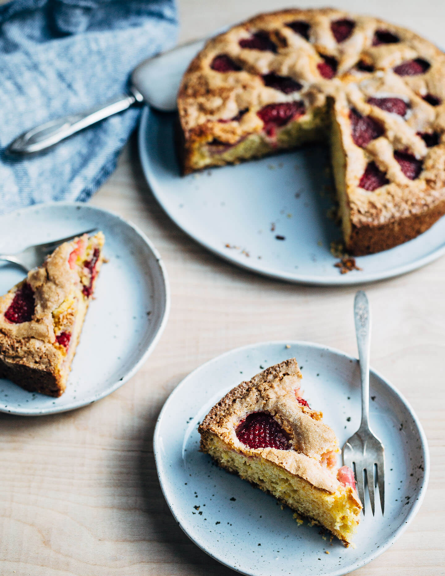 A rustic strawberry cornmeal cake sliced up and ready to eat. 