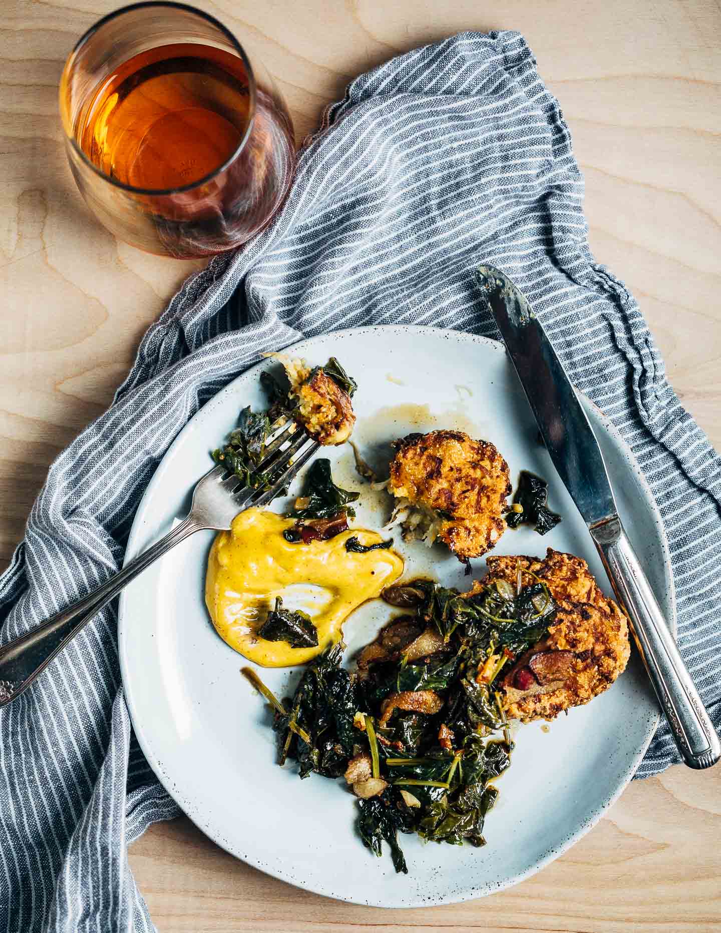 A simple recipe for turnip fritters topped with tender turnip greens, and served alongside pimenton aioli.