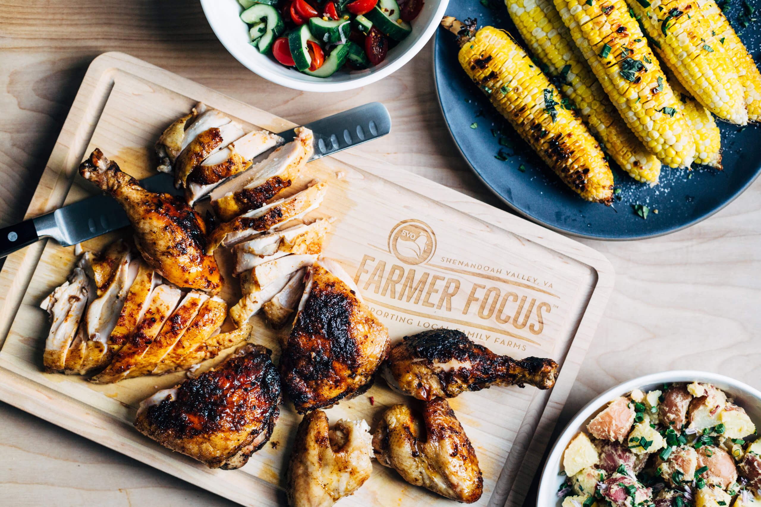 Carving up the whole grilled paprika and garlic chicken.