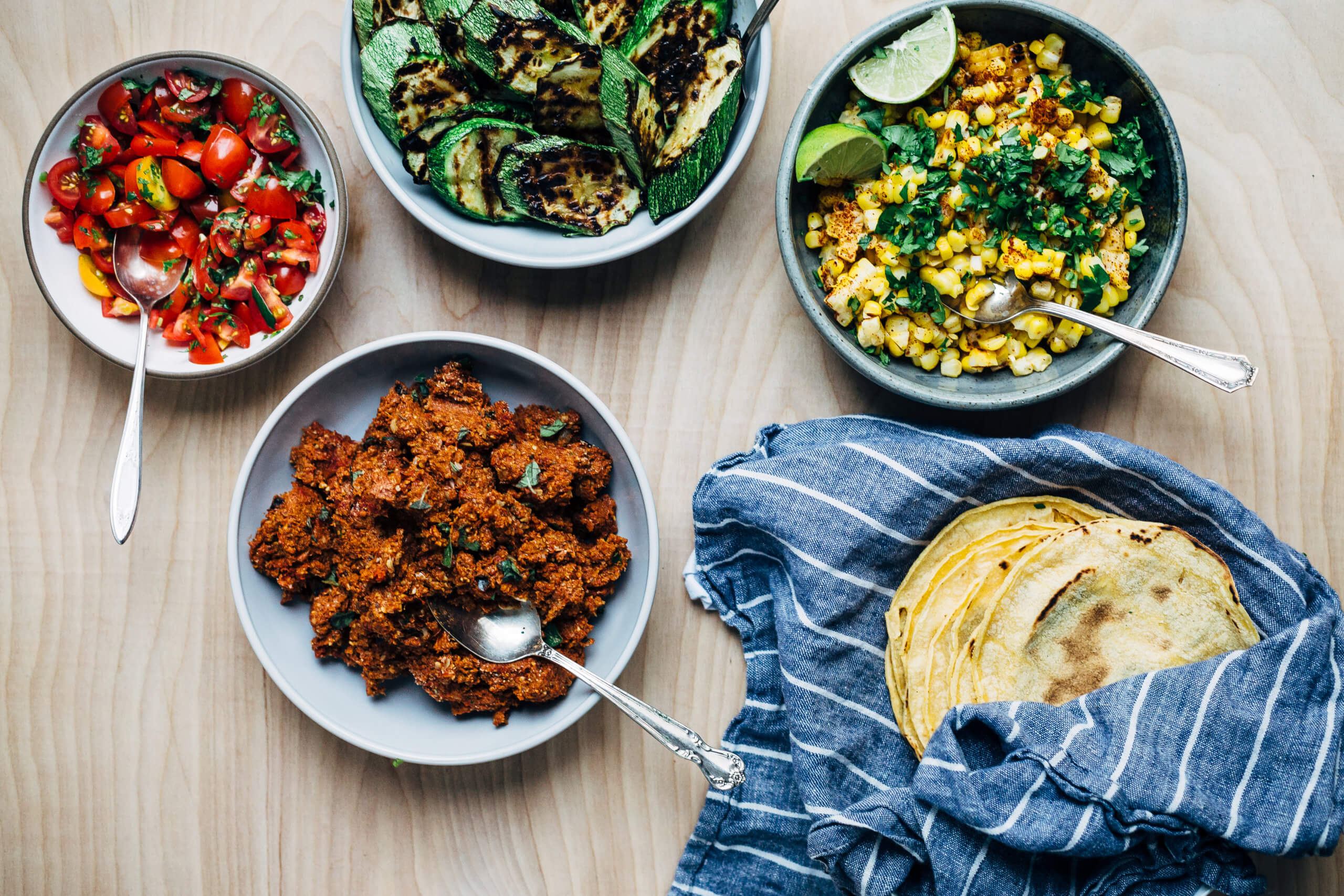 All the fixings for grilled zucchini and corn tacos with plant-based sunflower seed chorizo. 