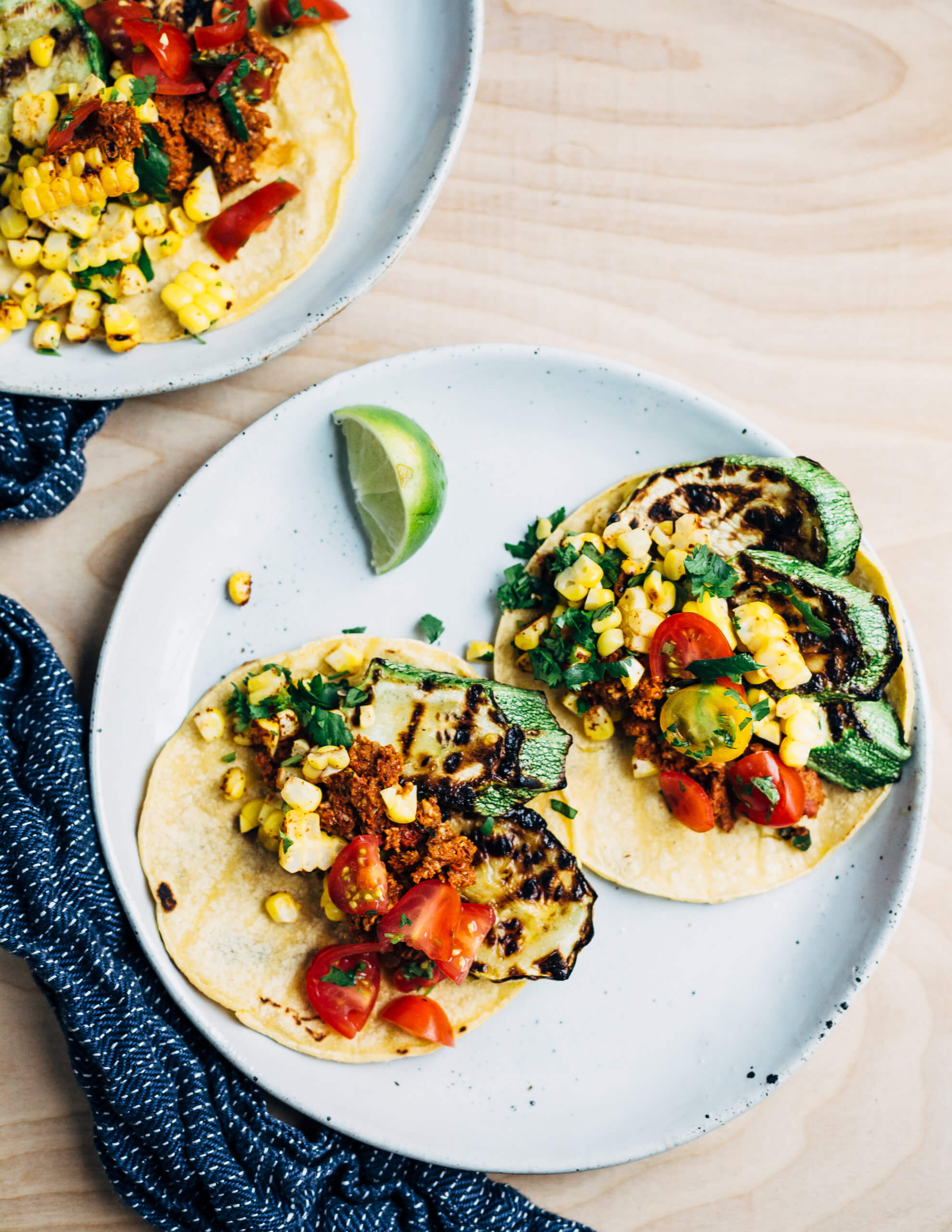 Summer-perfect grilled zucchini and corn tacos with a spicy, smoky plant-based chorizo topping made with sunflower seeds, dried guajillo chilies, and sun-dried tomatoes. 