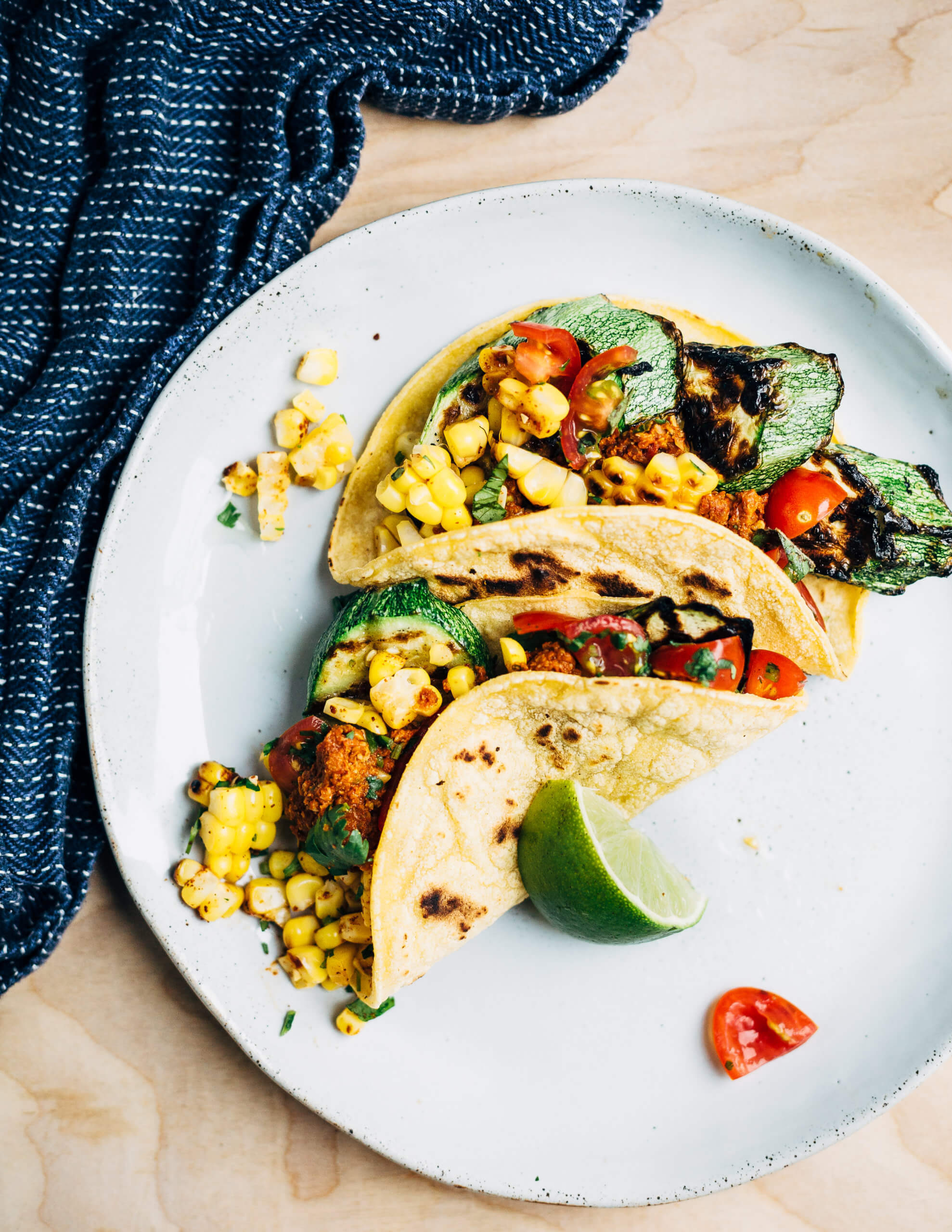 Summer-perfect grilled zucchini and corn tacos with a spicy, smoky plant-based chorizo topping made with sunflower seeds, dried guajillo chilies, and sun-dried tomatoes. 