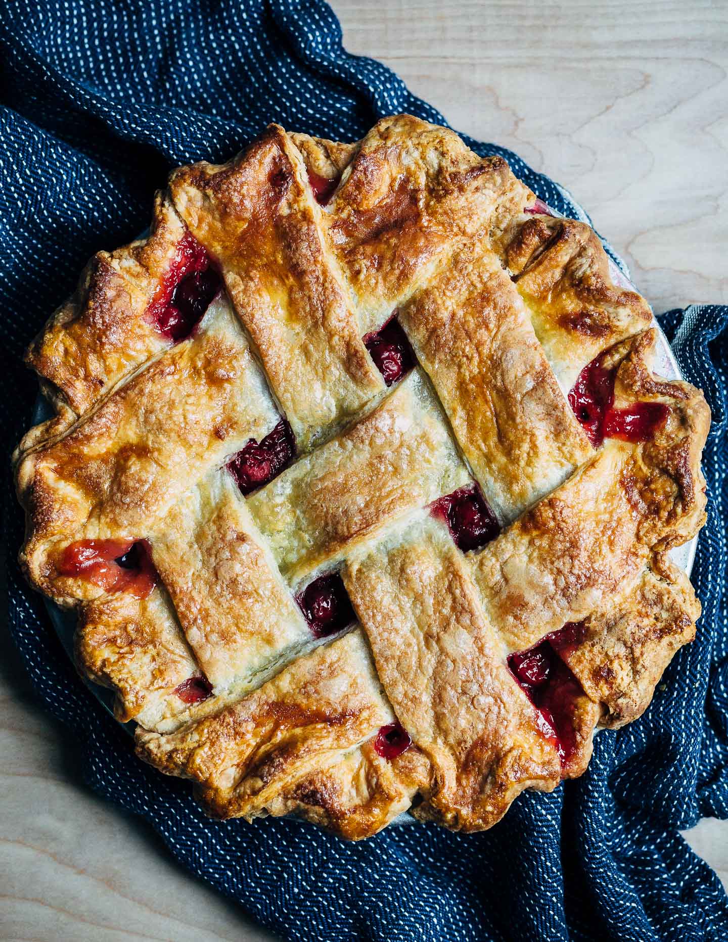 Lattice top sour cherry pie with a flaky, all butter crust, just out of the oven.