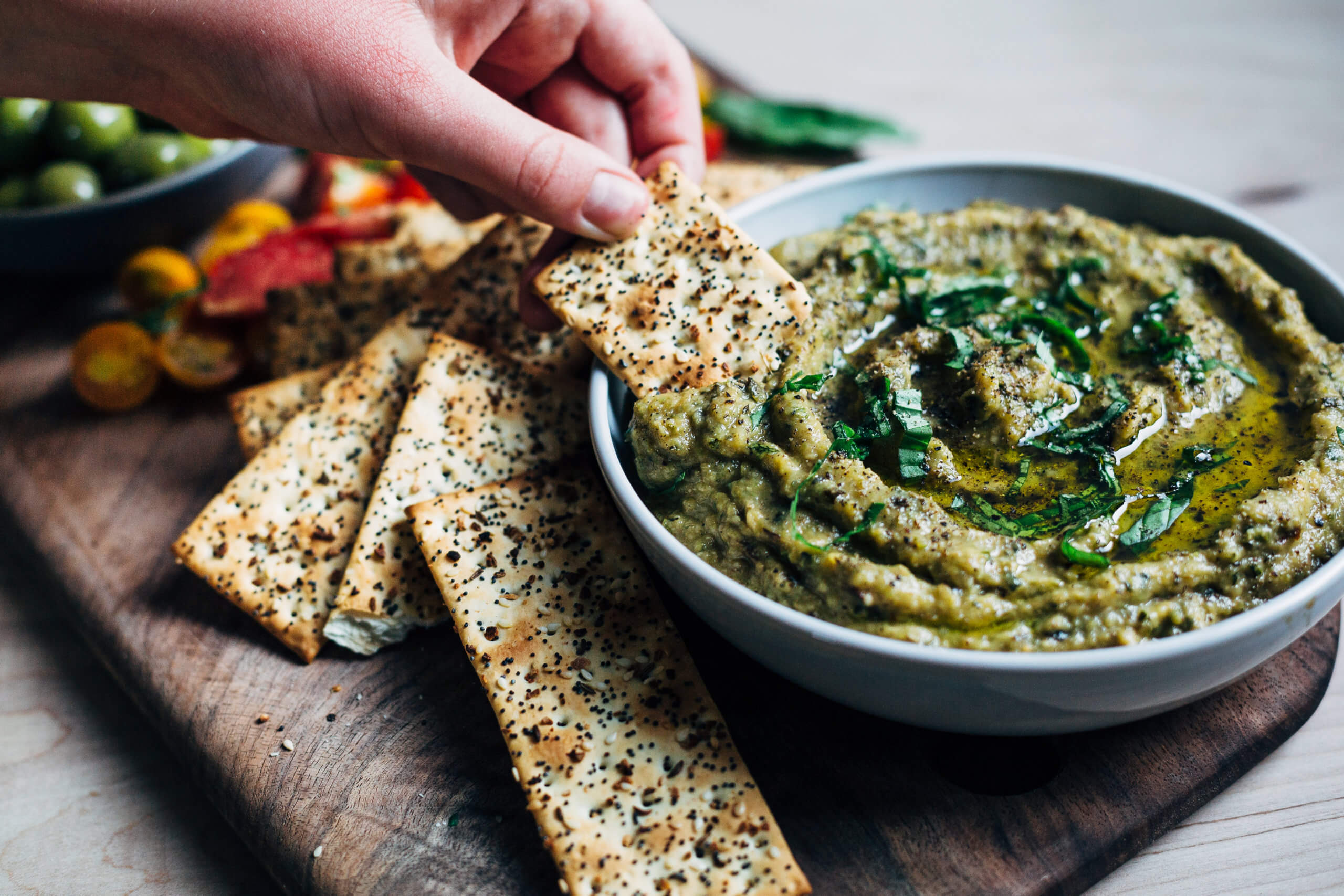 Roasted zucchini dip, served with seeded crackers and summer vegetables. 