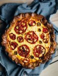 A deeply savory tomato pie that harnesses the acidic, faintly sweet edge of perfectly ripe summer tomatoes. There’s also a flaky whole wheat crust, eggs with bright orange yolks, and handfuls of sharp cheddar.