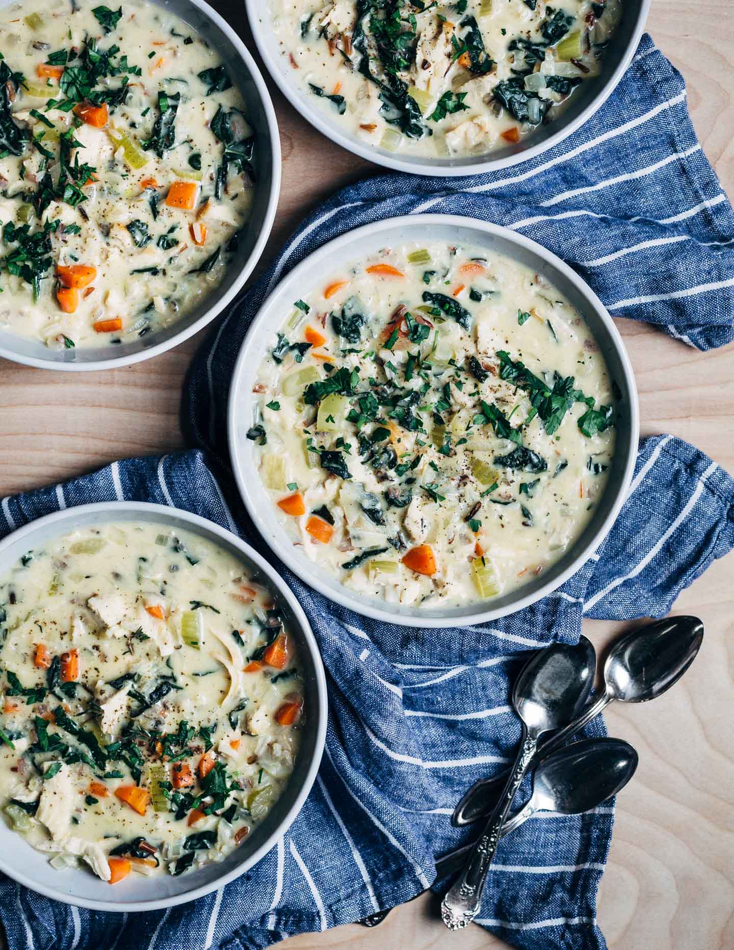 A creamy chicken and wild rice soup recipe with kale ribbons and fresh herbs. Comforting and delicious, chicken and wild rice soup is the perfect one-bowl dinner. 