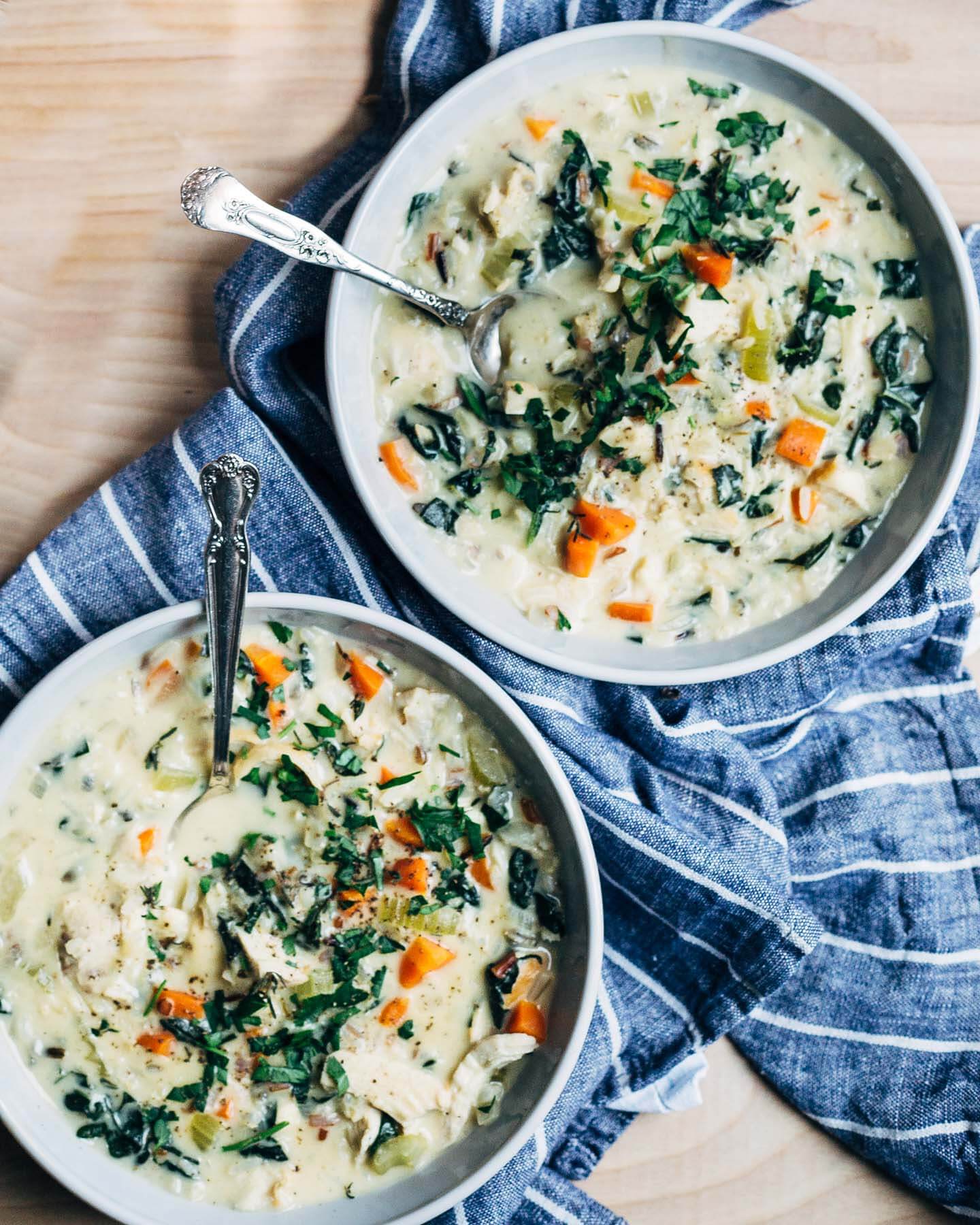 A creamy chicken and wild rice soup recipe with kale ribbons and fresh herbs. Comforting and delicious, chicken and wild rice soup is the perfect one-bowl dinner. 