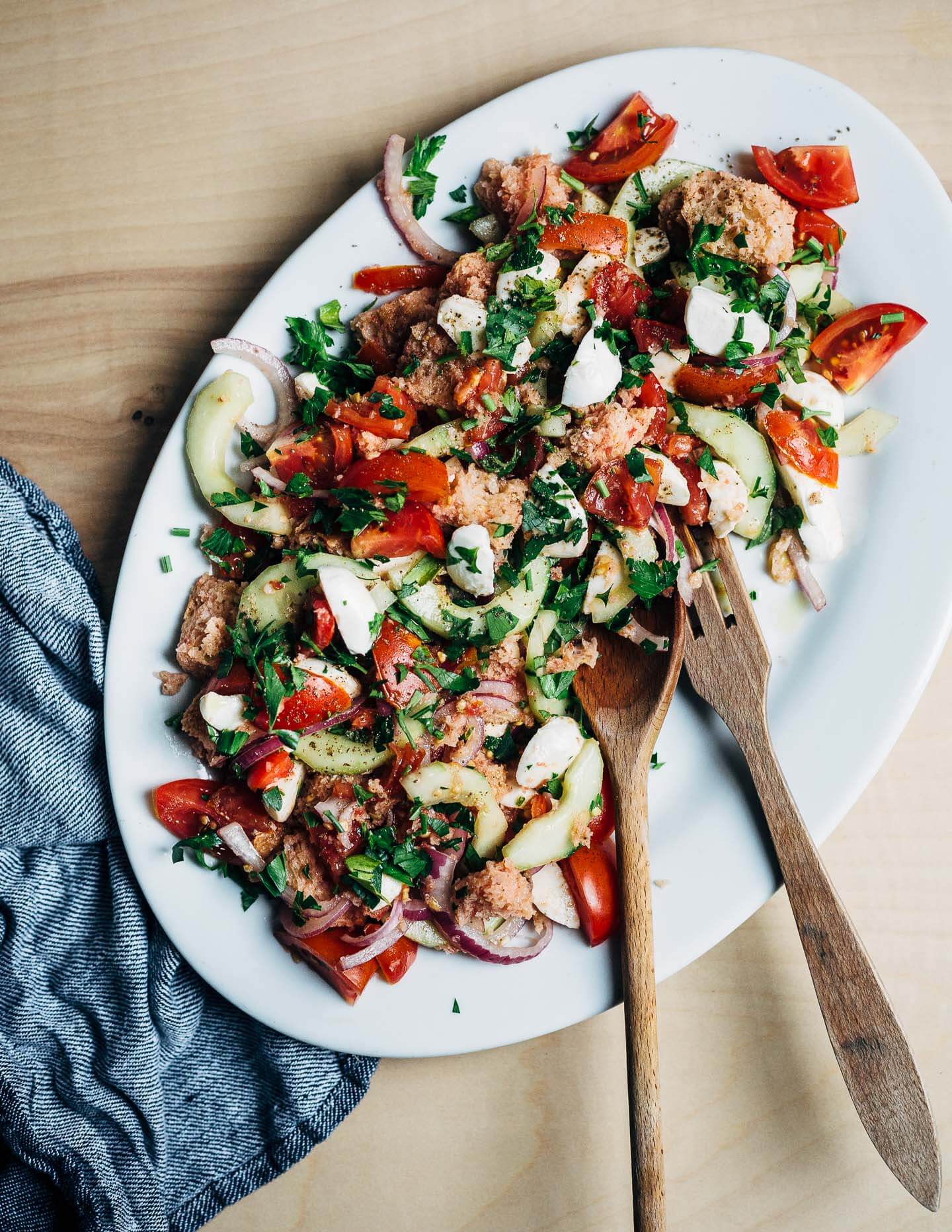 A classic summer salad, this panzanella with mozzarella and herbs features perfectly ripe summer tomatoes, a punchy garlic and anchovy vinaigrette.