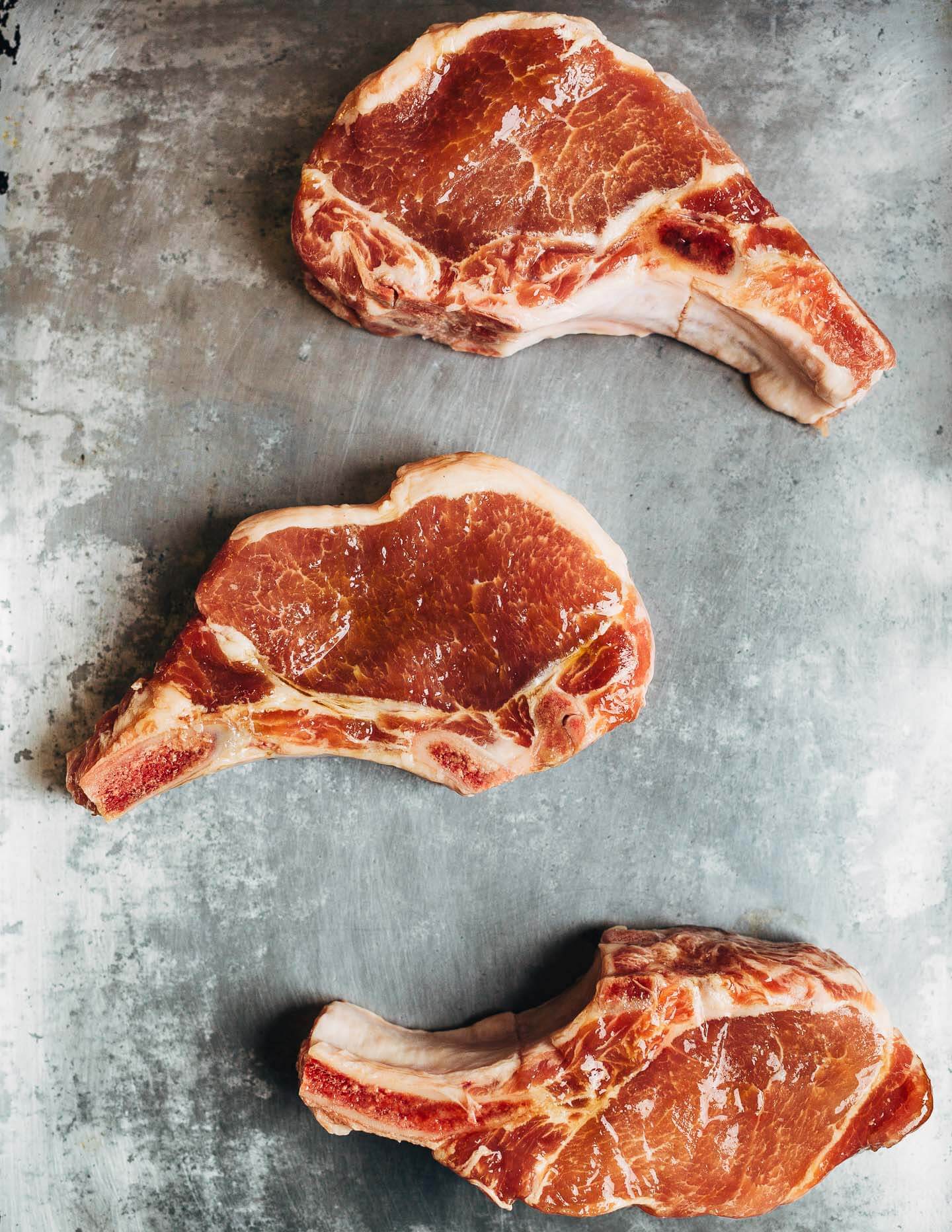 Bone-in pork chops with sea salt and brown sugar. 