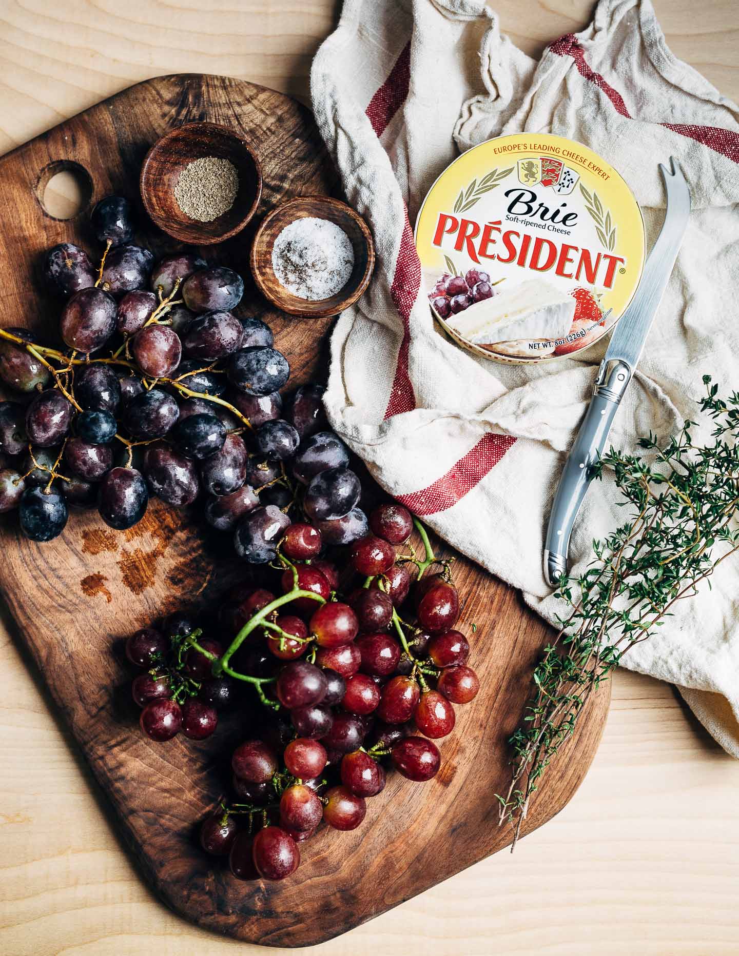 Black and red grapes, fresh thyme, and President brie. 