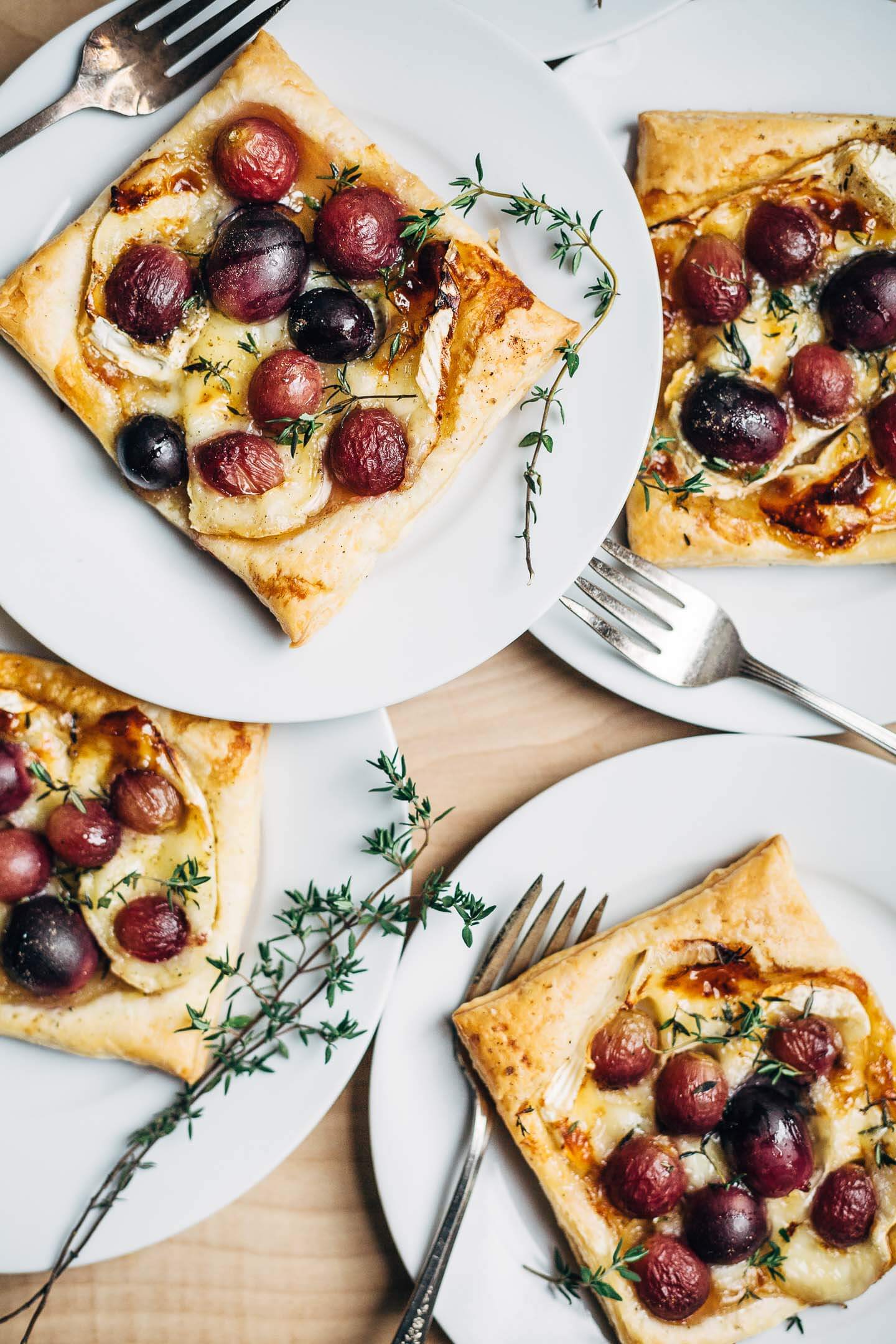 Effortless brie and roasted grape tarts, plated and ready to serve. 
