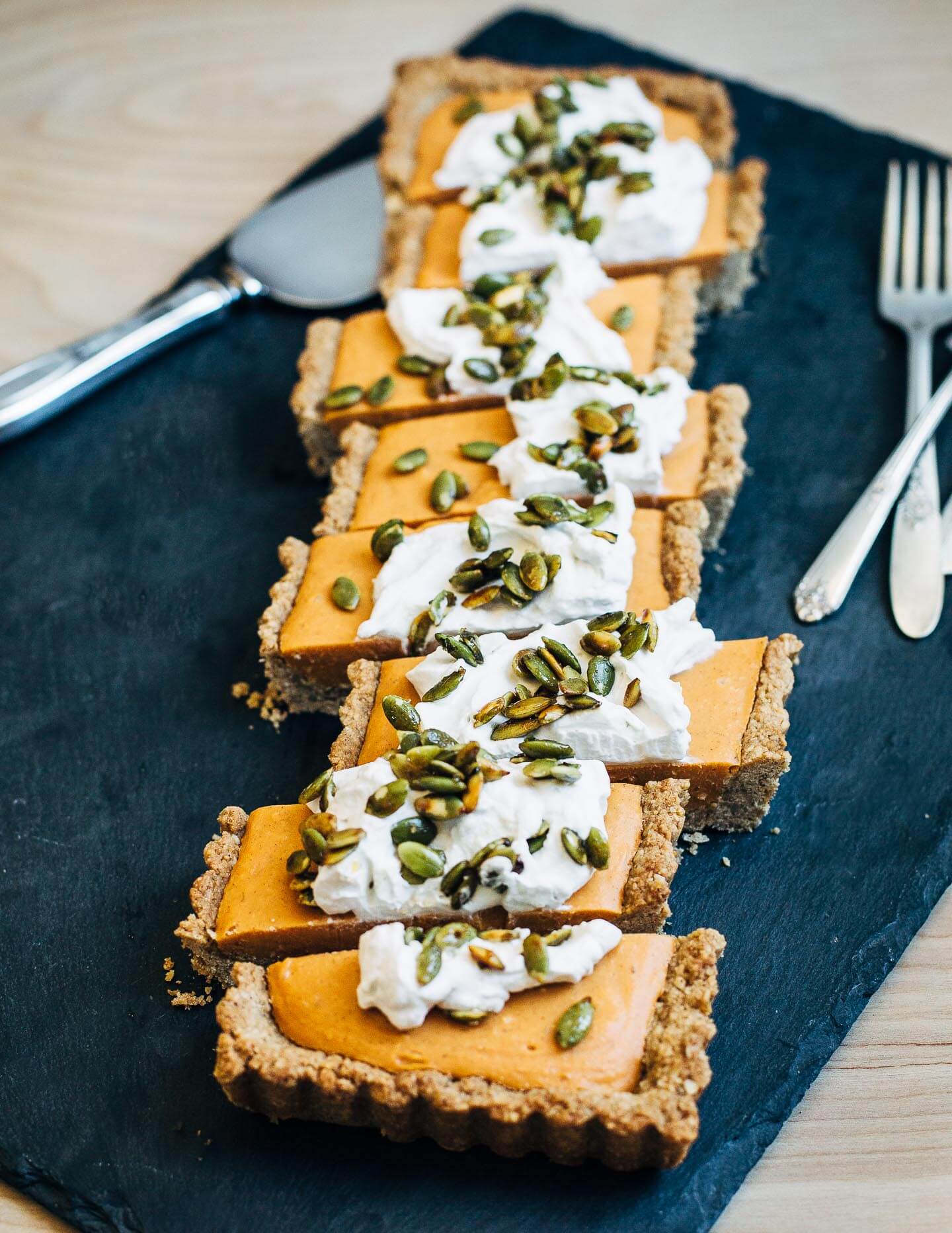 This vegan, gluten-free coconut cream and sweet potato tart has a silky texture with the spice and flavor of a classic sweet potato pie. It's topped with maple-sweetened coconut cream and salty-sweet toasted pepitas.