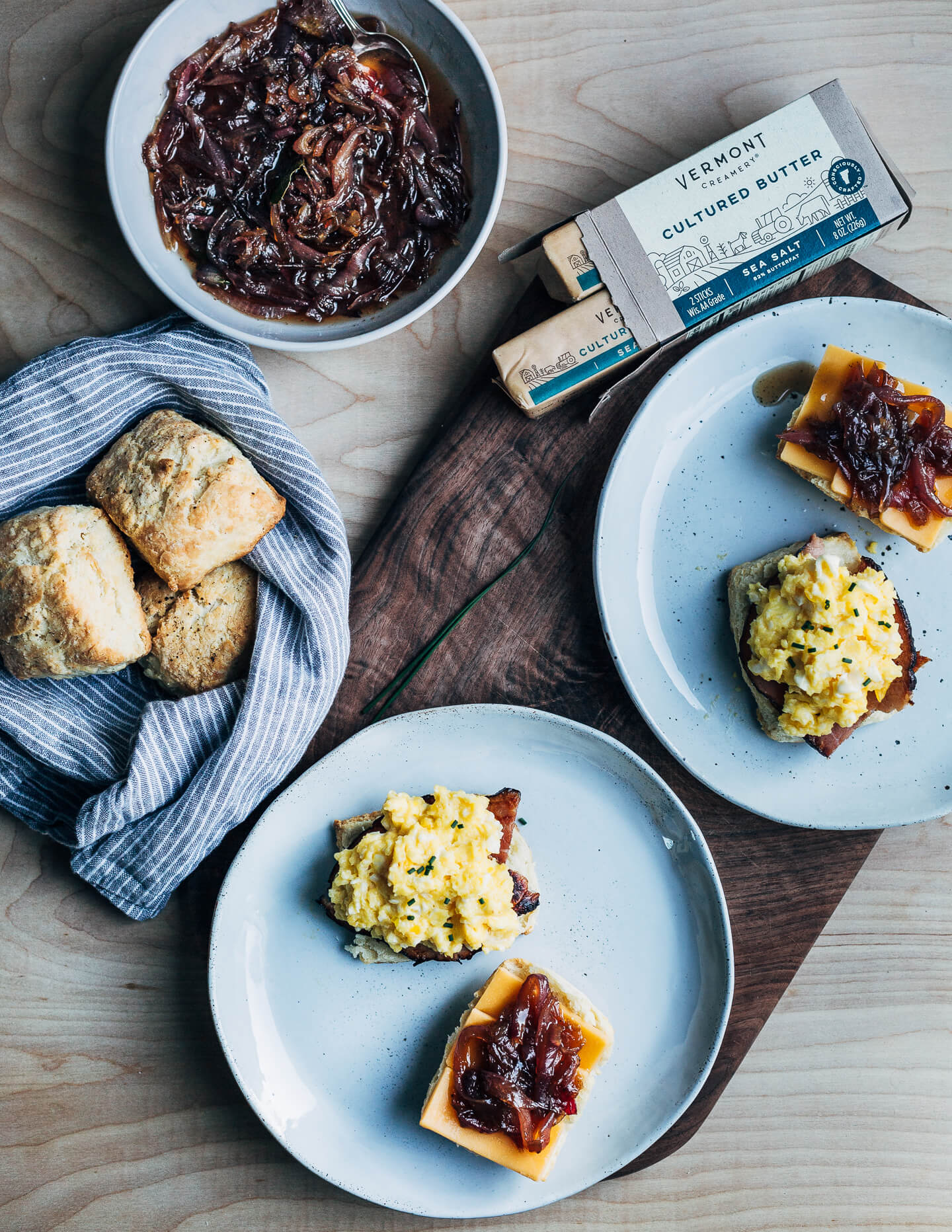 Perfect for a relaxed weekend or a holiday brunch, these layered biscuit sandwiches begin with airy homemade biscuits and are topped with thick-cut ham, slow-scrambled eggs, sharp cheddar, and a quick red onion jam.