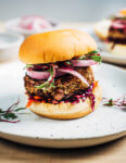 These vegetarian shiitake mushroom and tahini veggie burgers with a savory sweet red cabbage and carrot slaw, quick-pickles, and beet microgreens are a super flavorful, wonderfully satisfying dinner option.