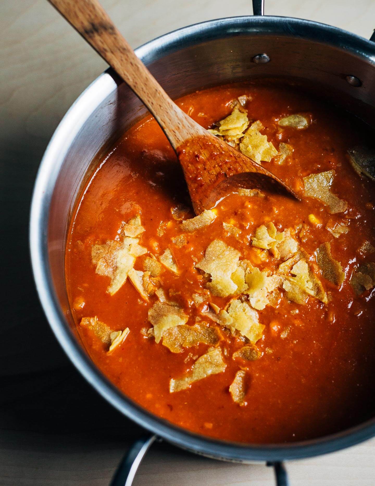 Vegan tortilla soup with crumbled tortillas.