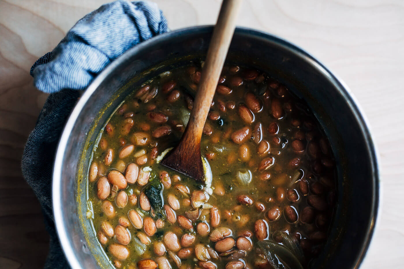 A pot of cooked brothy pinto beans