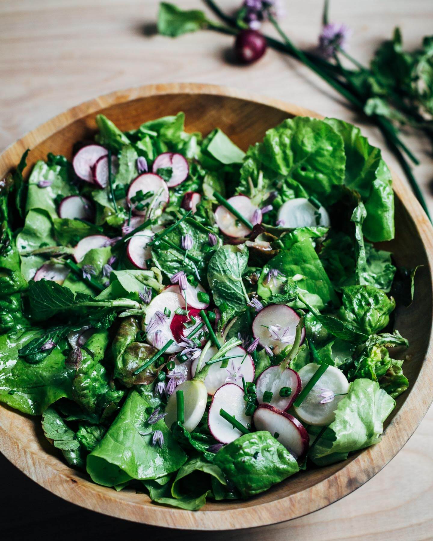 A simple salad of delicate lettuces, jewel-toned radishes, and chives topped with a perfectly balanced, classic vinaigrette.