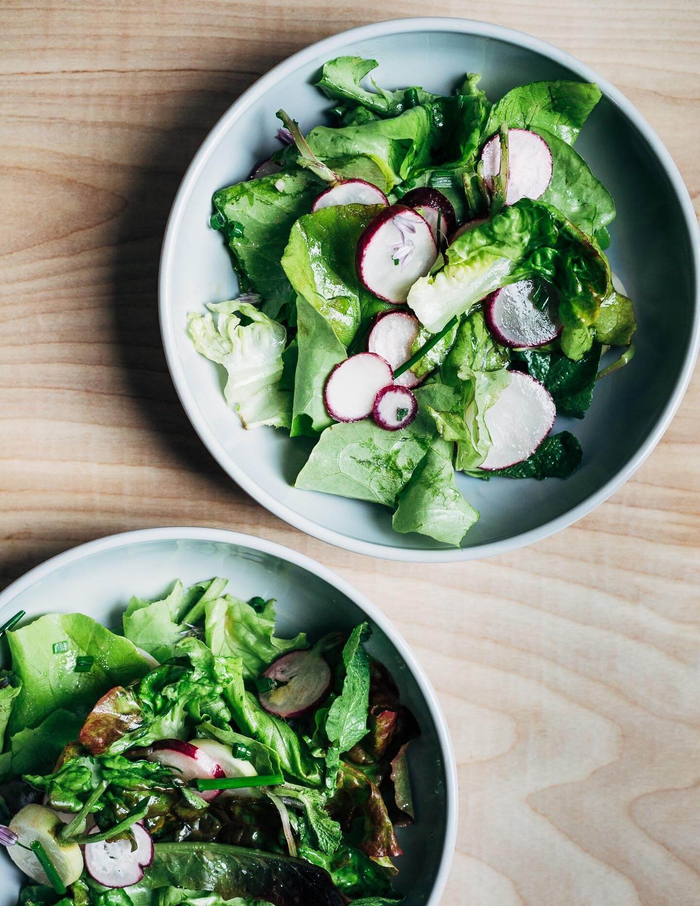 A simple green salad in small bowls. 