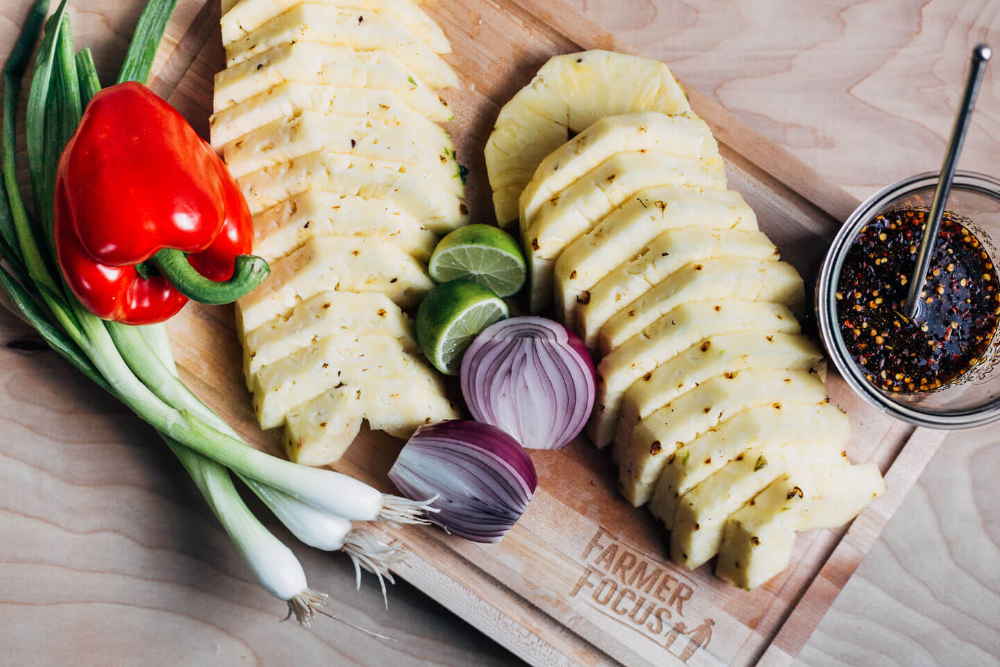 Sliced pineapple and onions, with red peppers and a lime-soy marinade. 