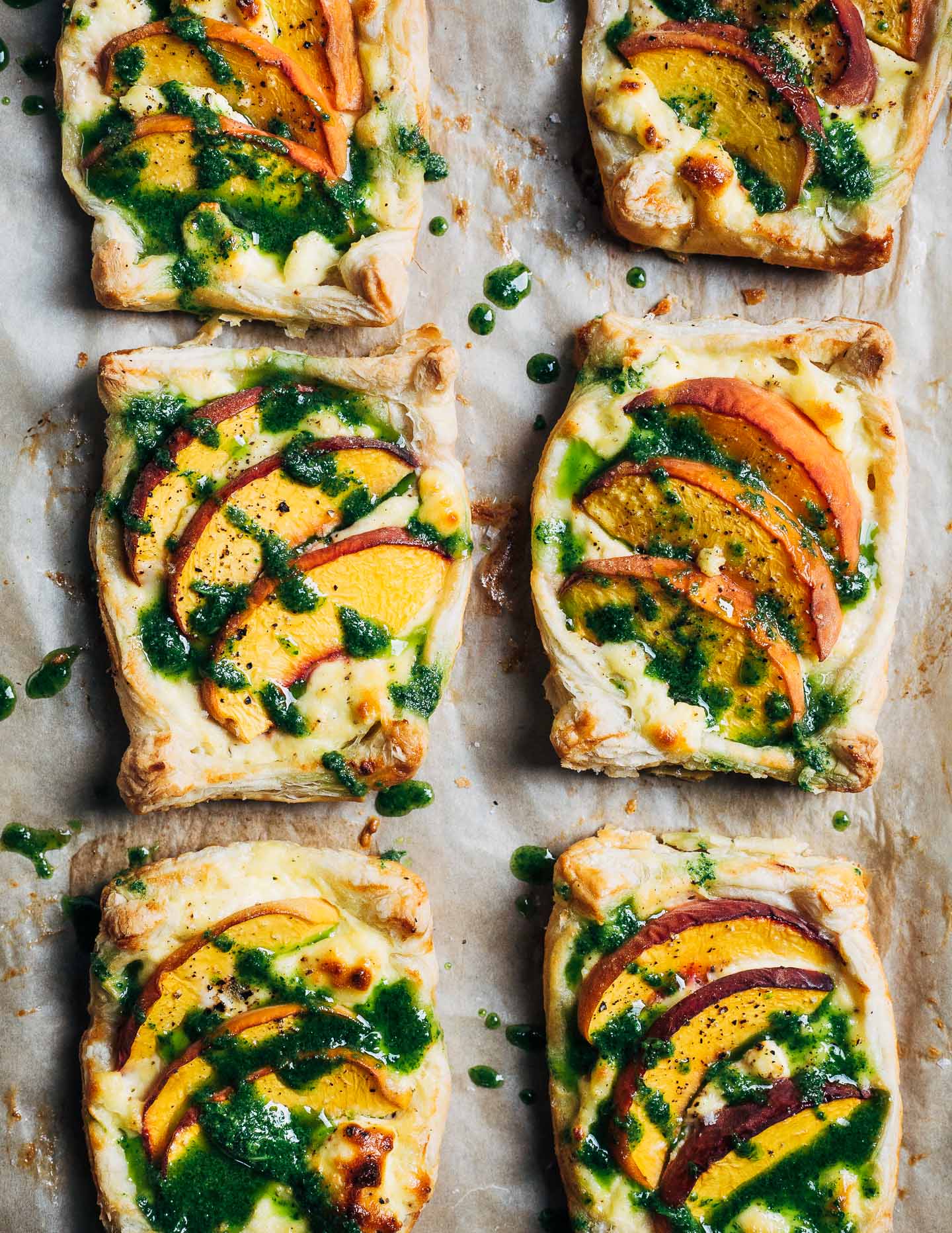 Finished savory peach and ricotta tarts, drizzled with fresh basil oil. 