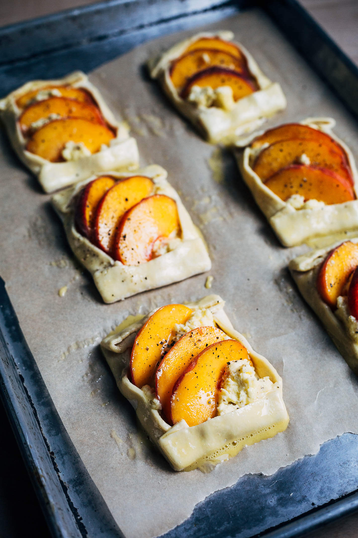 Savory peach and ricotta tarts, headed for the oven. 