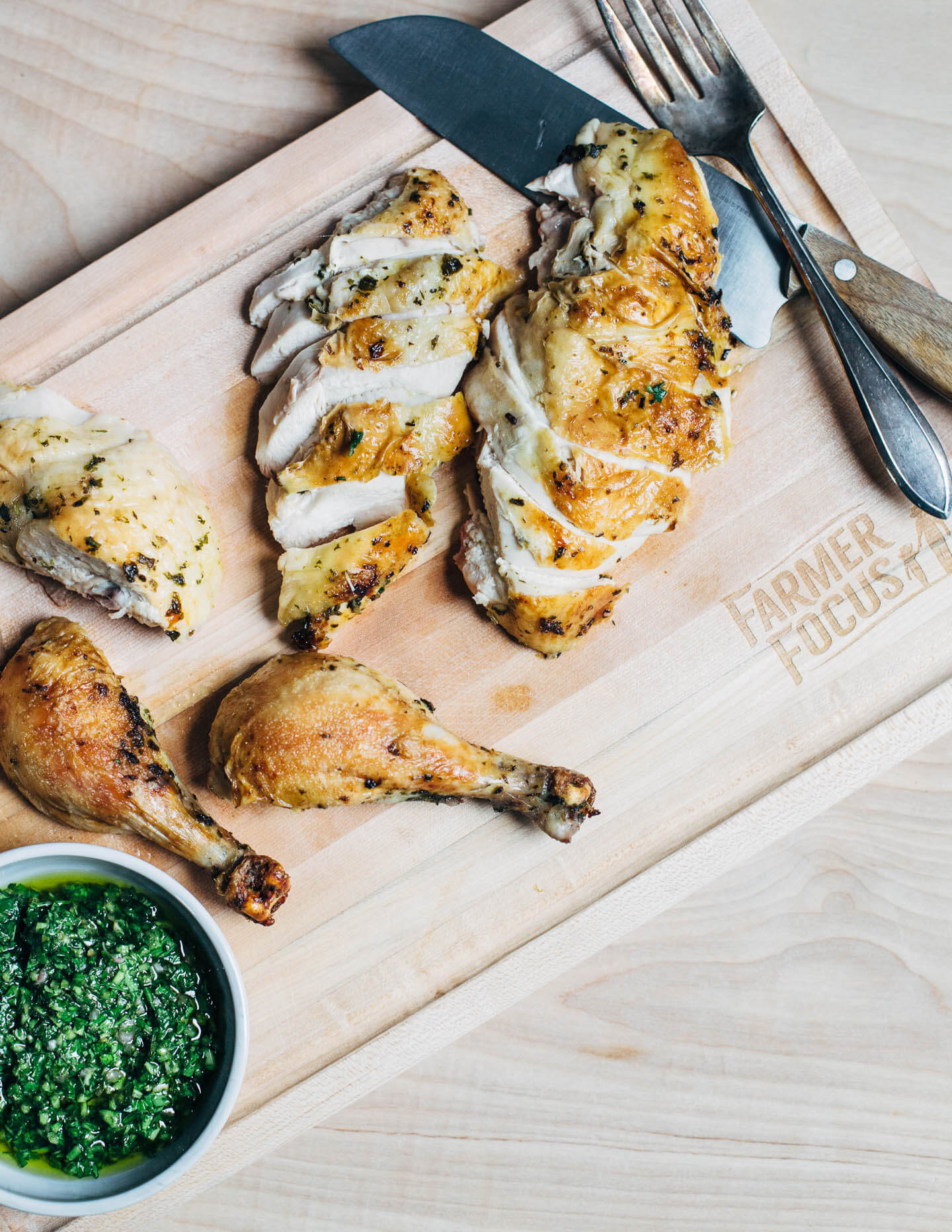 Carving a whole roasted chimichurri chicken.