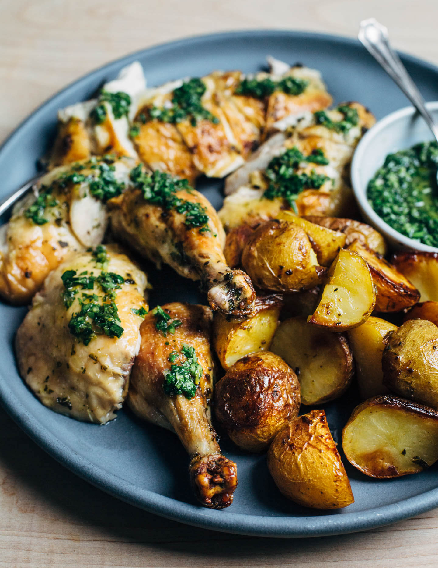 Fall weather means it's the right time to turn on your oven and make this crisp-skinned, deeply flavorful chimichurri roasted chicken with schmaltzy Yukon gold potatoes.