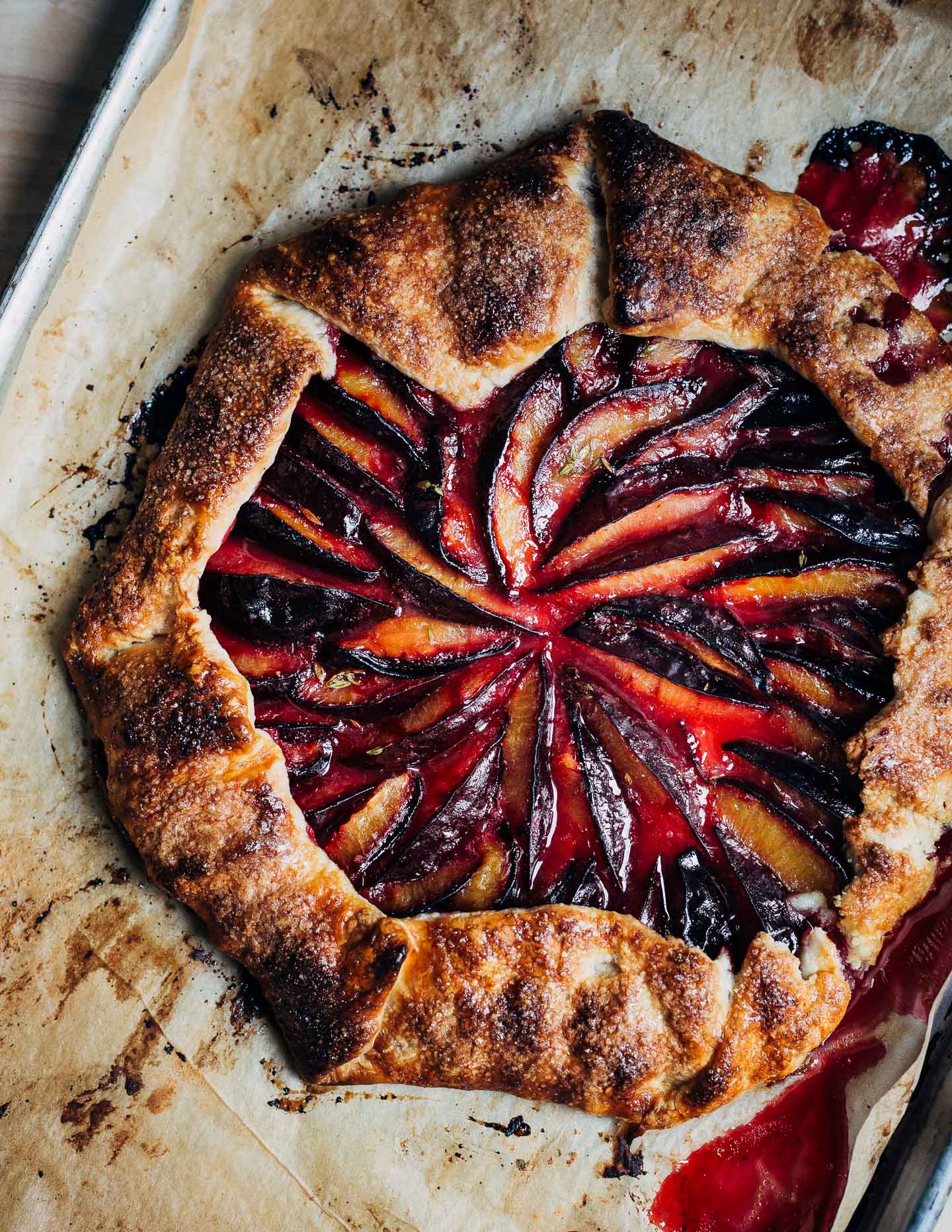 A beautifully rustic, of-the-moment Damson plum galette with fresh thyme, ground star anise, and a flaky all-butter crust.