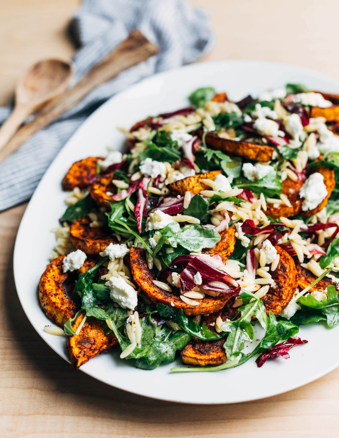 This roasted butternut squash and orzo salad with sturdy fall greens and crumbled goat cheese is beautiful, delicious, and perfectly autumnal.