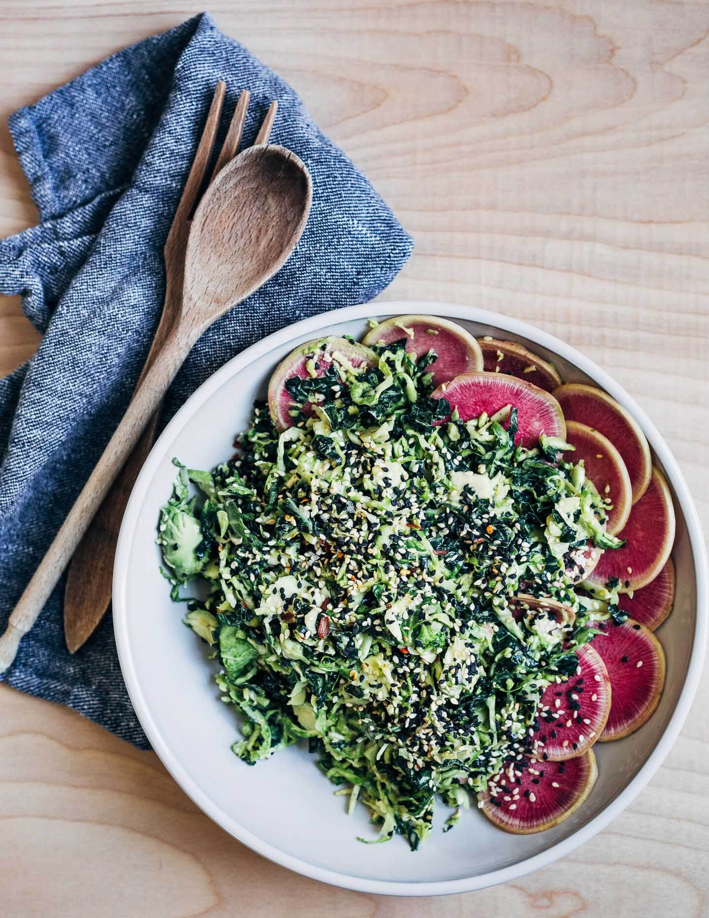 This shaved Brussels sprout and kale salad with lemon-tahini dressing and toasted sesame seeds has lots of sesame flavor and just a little heat.