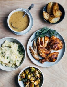 Roasted half chicken with gravy, Brussels sprouts, onions, mashed potatoes, and mac and cheese.