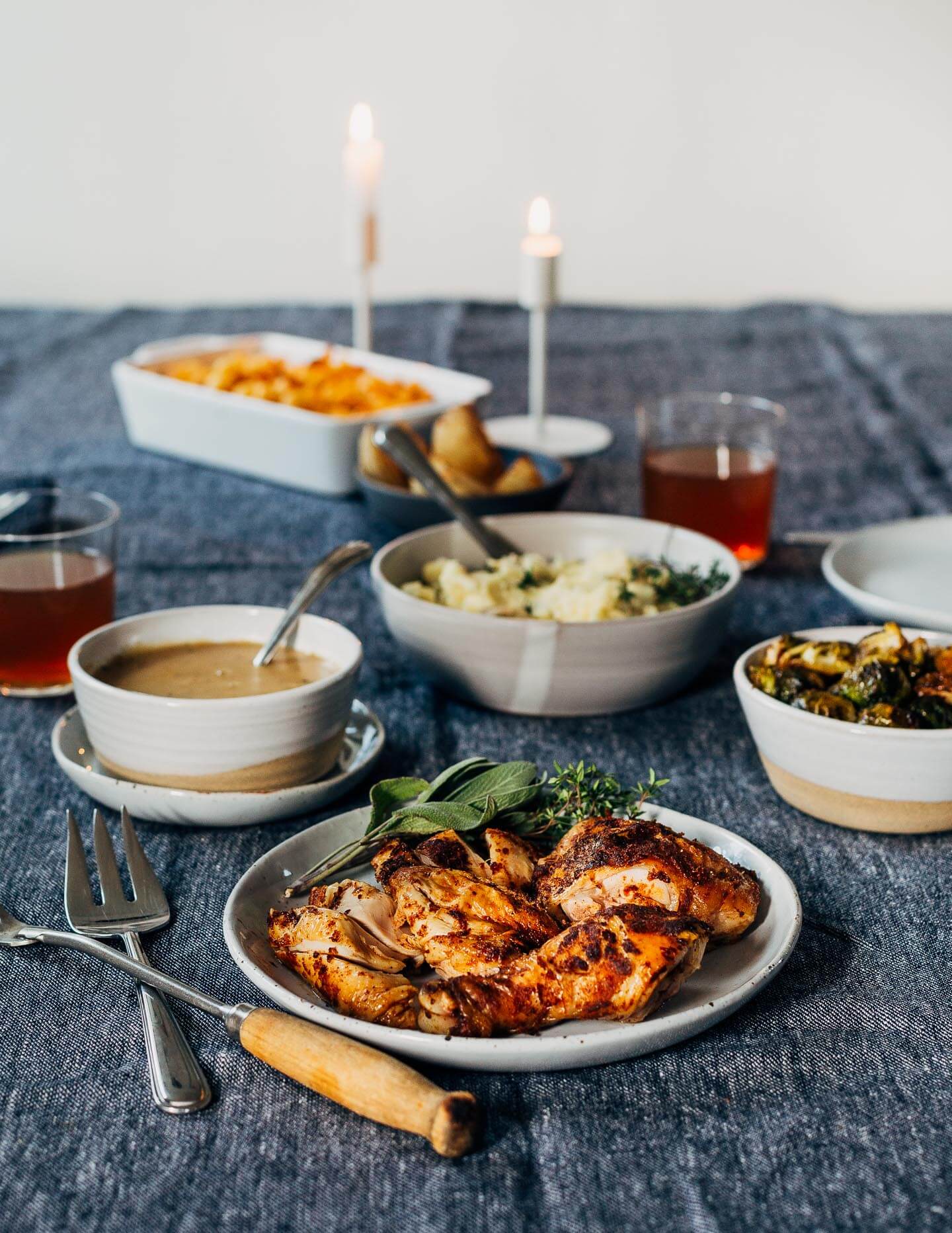 A Thanksgiving feast for two, featuring recipes for sheet pan half chicken with roasted Brussels sprouts and onions, and a simple gravy made with the pan drippings. Serve with mashed potatoes and mac and cheese, and you have the perfect Thanksgiving for two (with plenty of leftovers!).