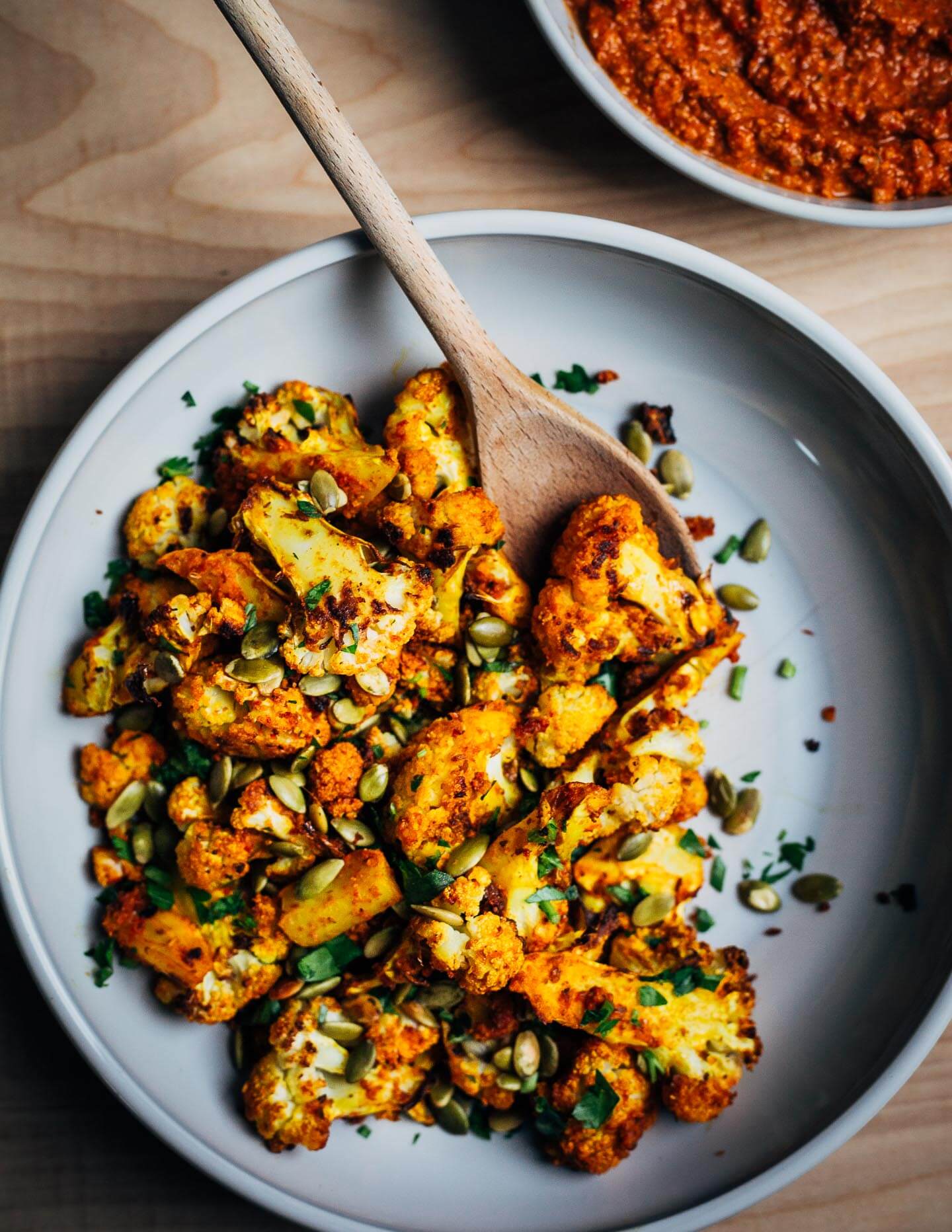 This recipe for romesco-roasted cauliflower coaxes bold, vibrant flavor out of that wintertime staple, roasted cauliflower, along with smoky depth from the romesco sauce and the crunch of salty pepitas.