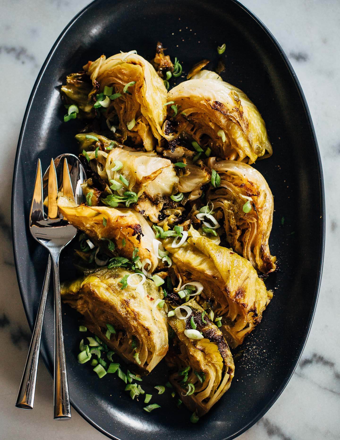 A two hour stint in a low oven makes for meltingly tender braised cabbage wedges cooked with spring onions and a hint of lemon.