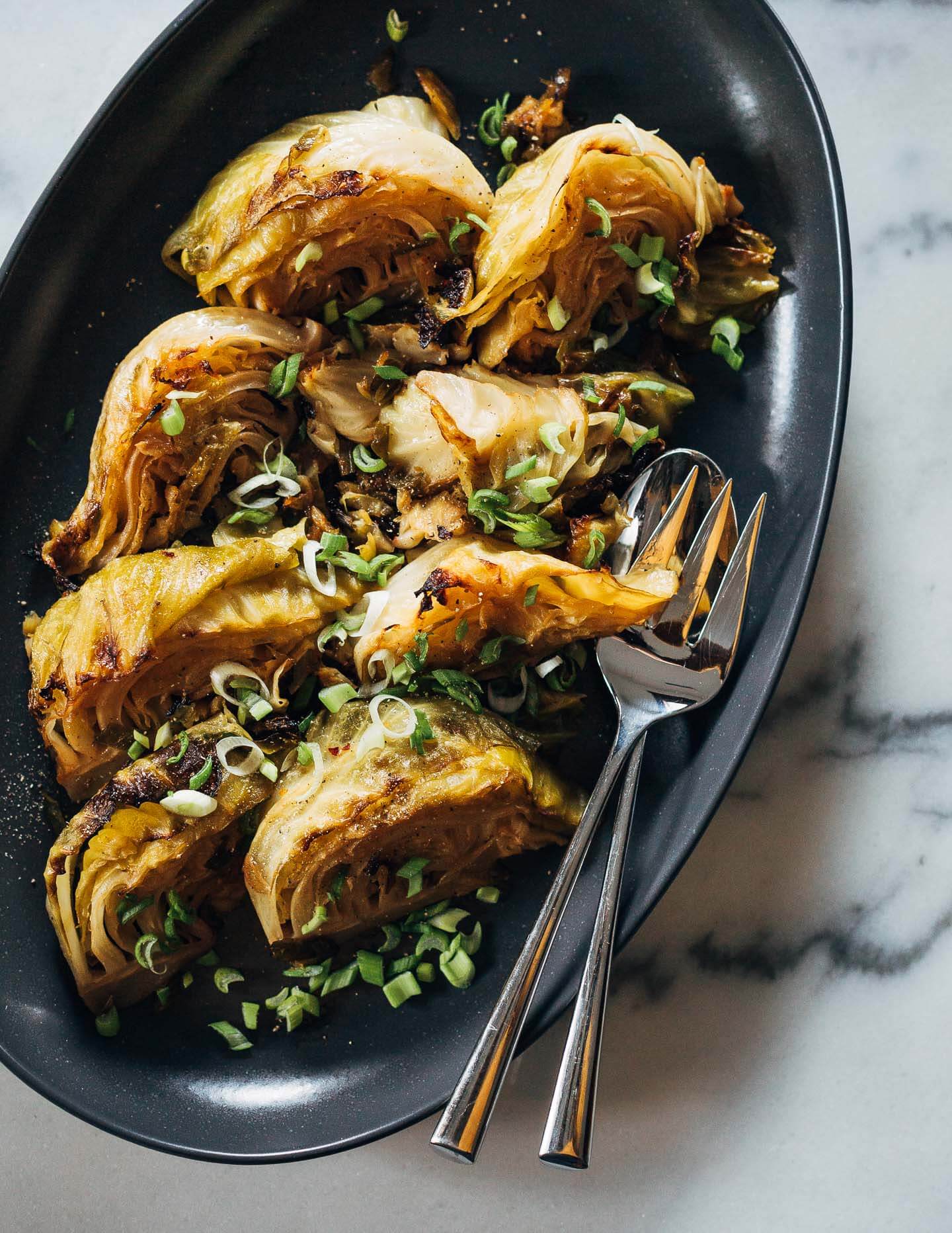 A two hour stint in a low oven makes for meltingly tender braised cabbage wedges cooked with spring onions and a hint of lemon.