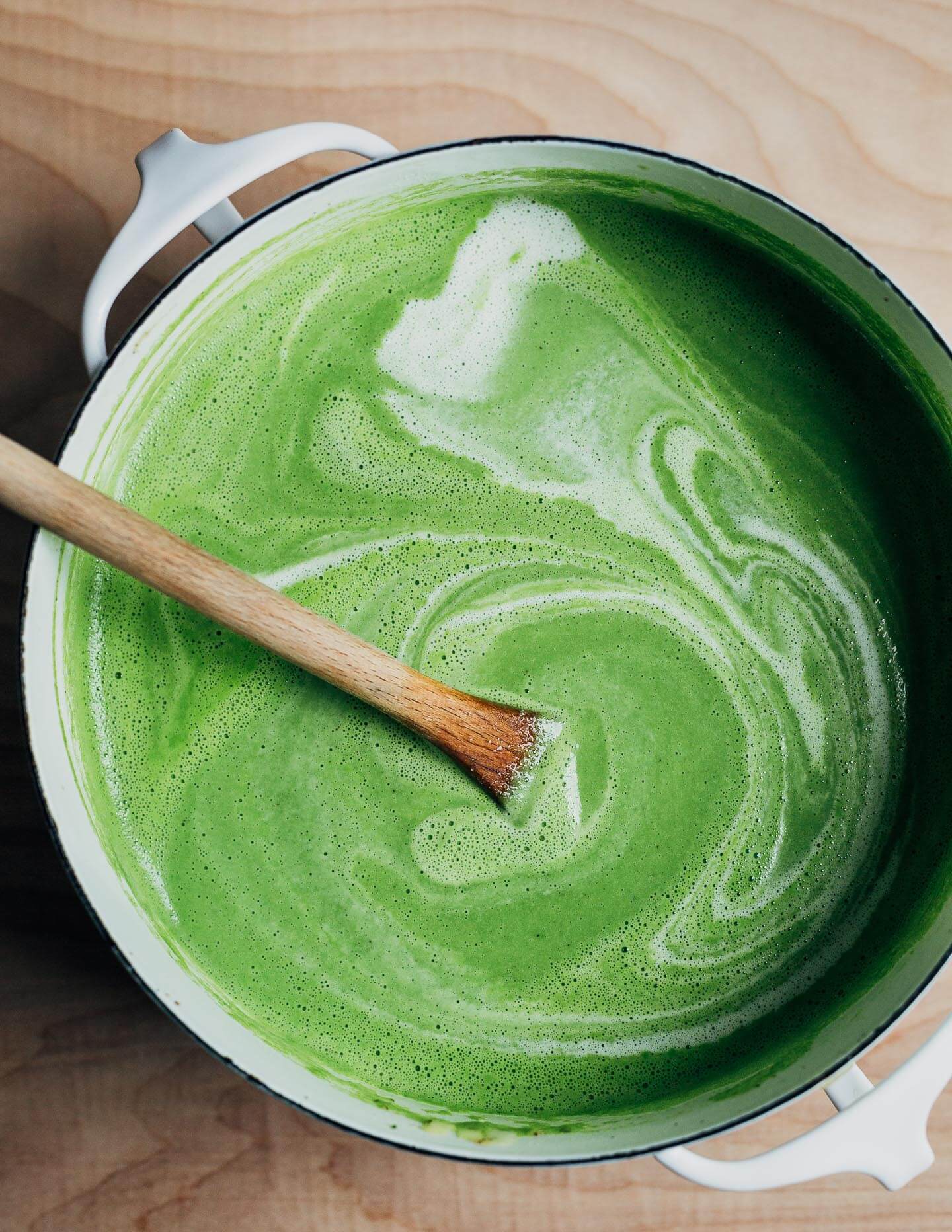 Adding the cream to the pureed asparagus soup